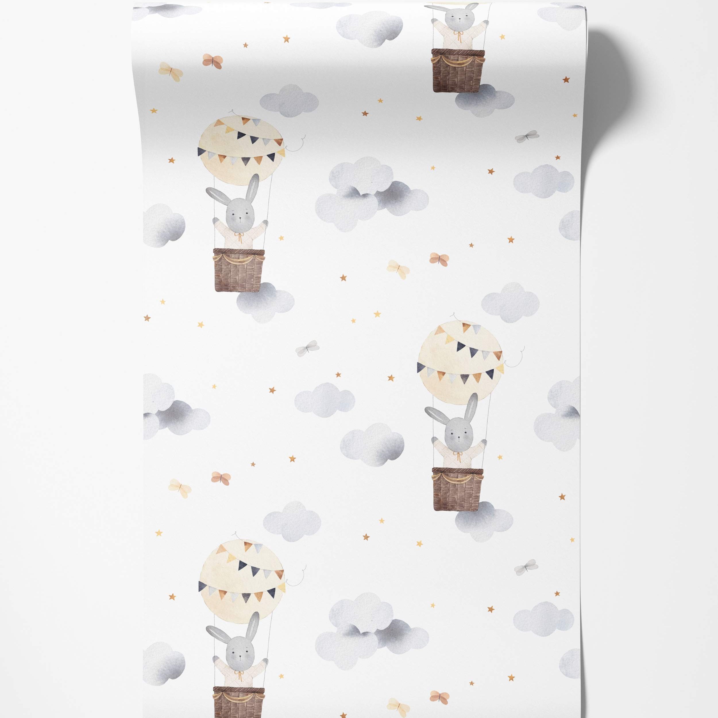 Watercolor wallpaper featuring cute grey bunnies in hot air balloons floating among grey clouds and yellow stars on a white background.