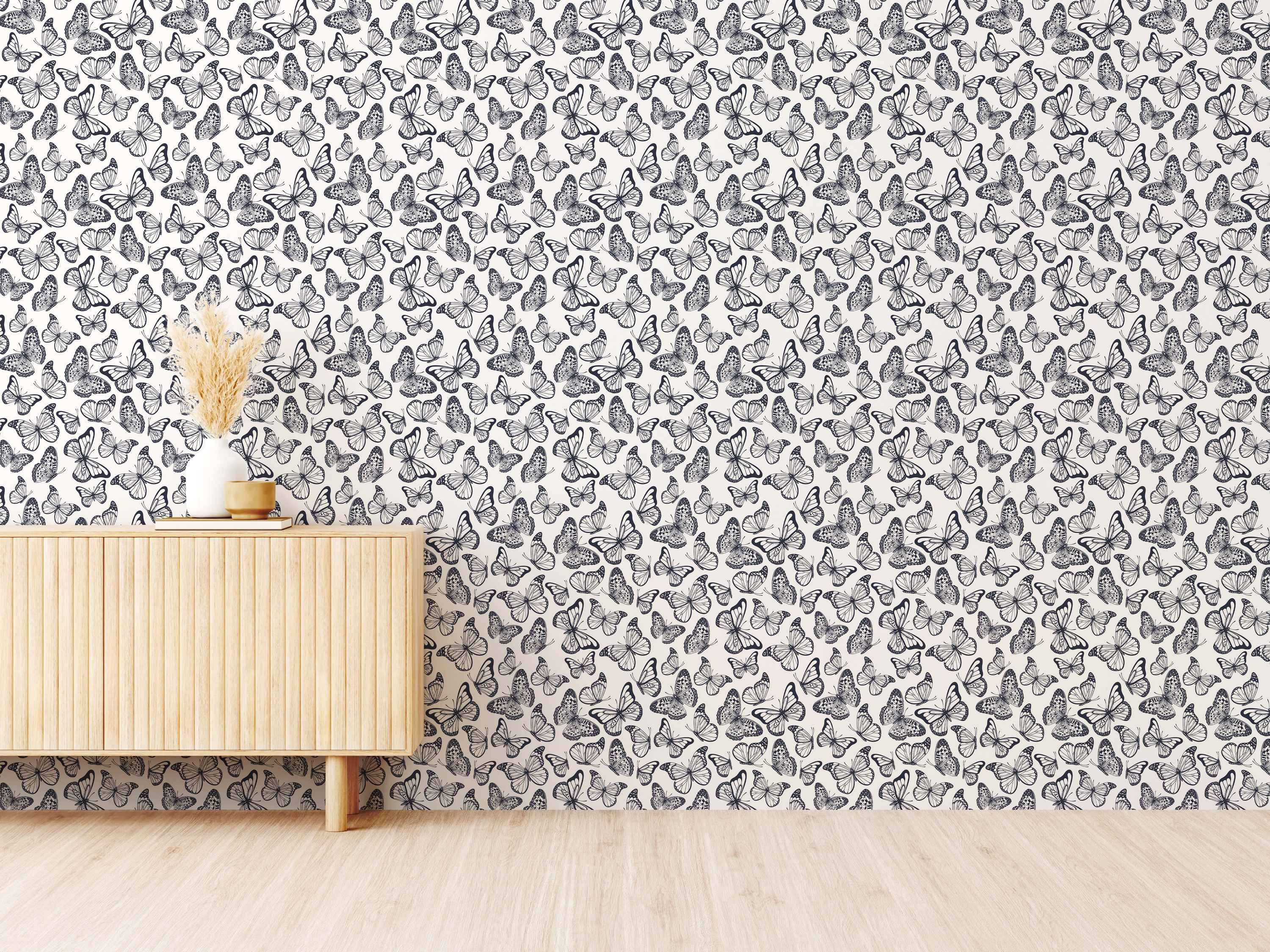 Wallpaper featuring a repeating pattern of detailed black and white illustrated butterflies scattered across an off-white background.