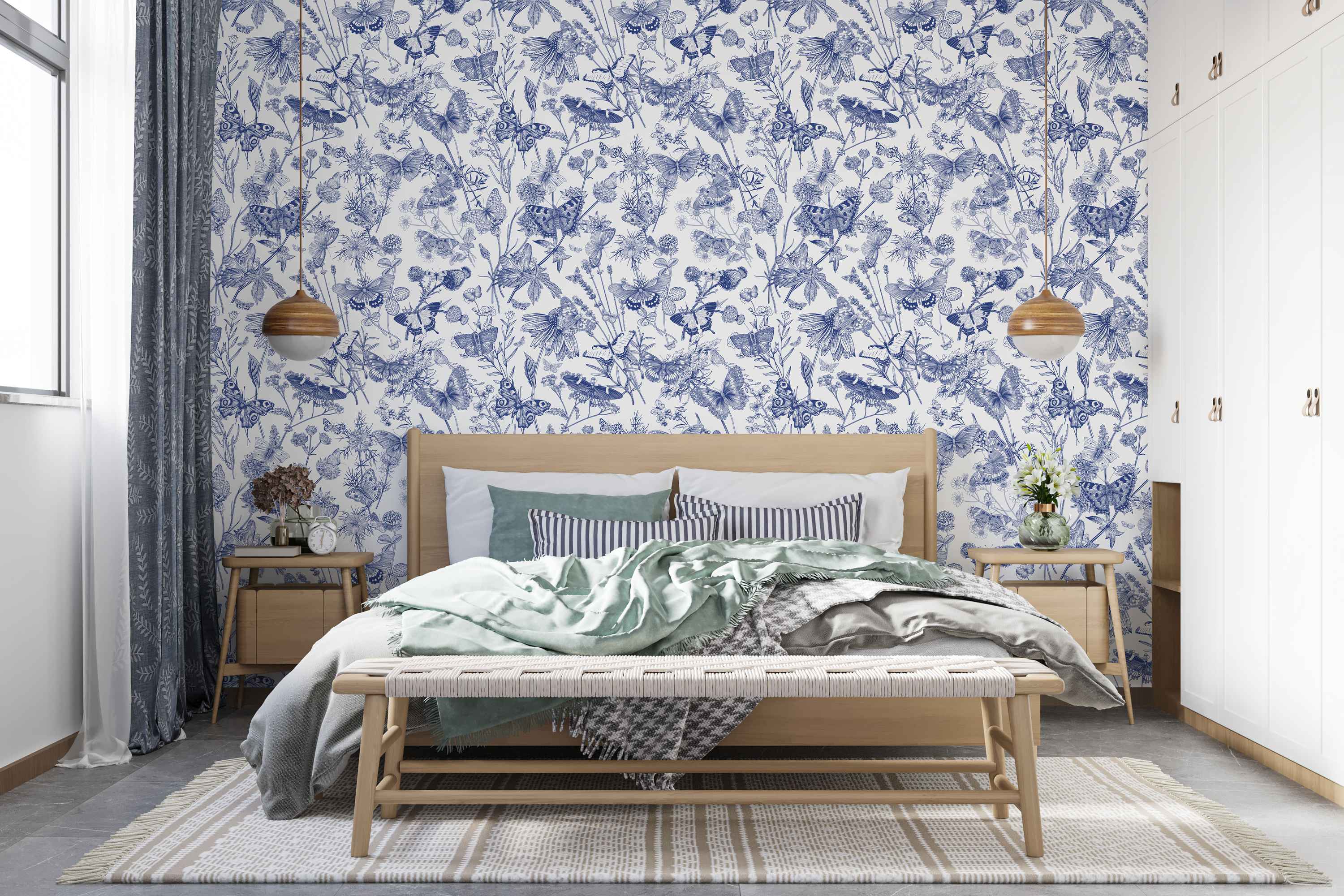Blue and white botanical wallpaper featuring sketched butterflies and wildflowers in a repeating pattern.