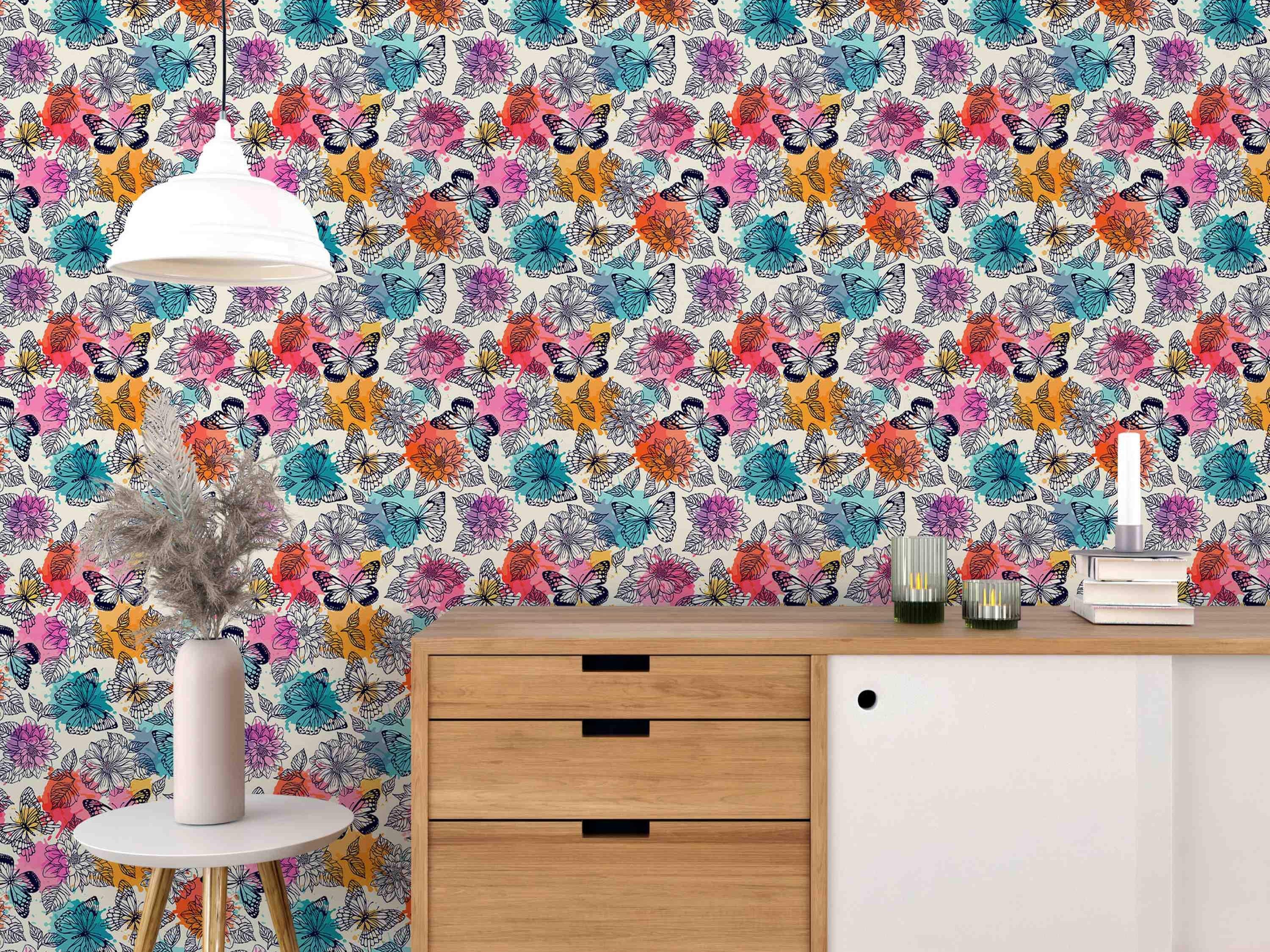 Wallpaper featuring line art butterflies and flowers over splashes of pink, orange, teal, and purple watercolor.
