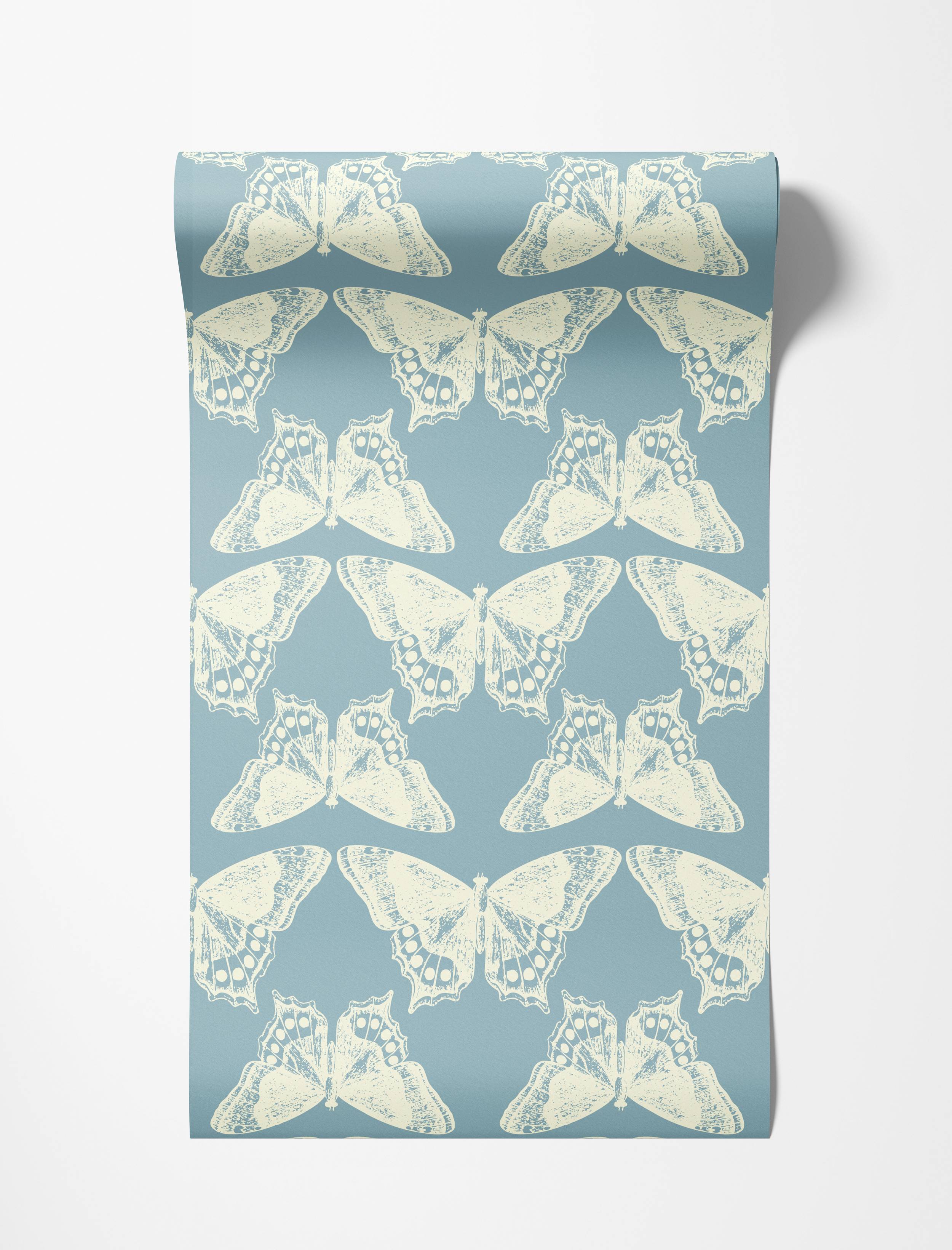 A repeating wallpaper pattern of distressed cream butterflies arranged symmetrically on a slate blue background.