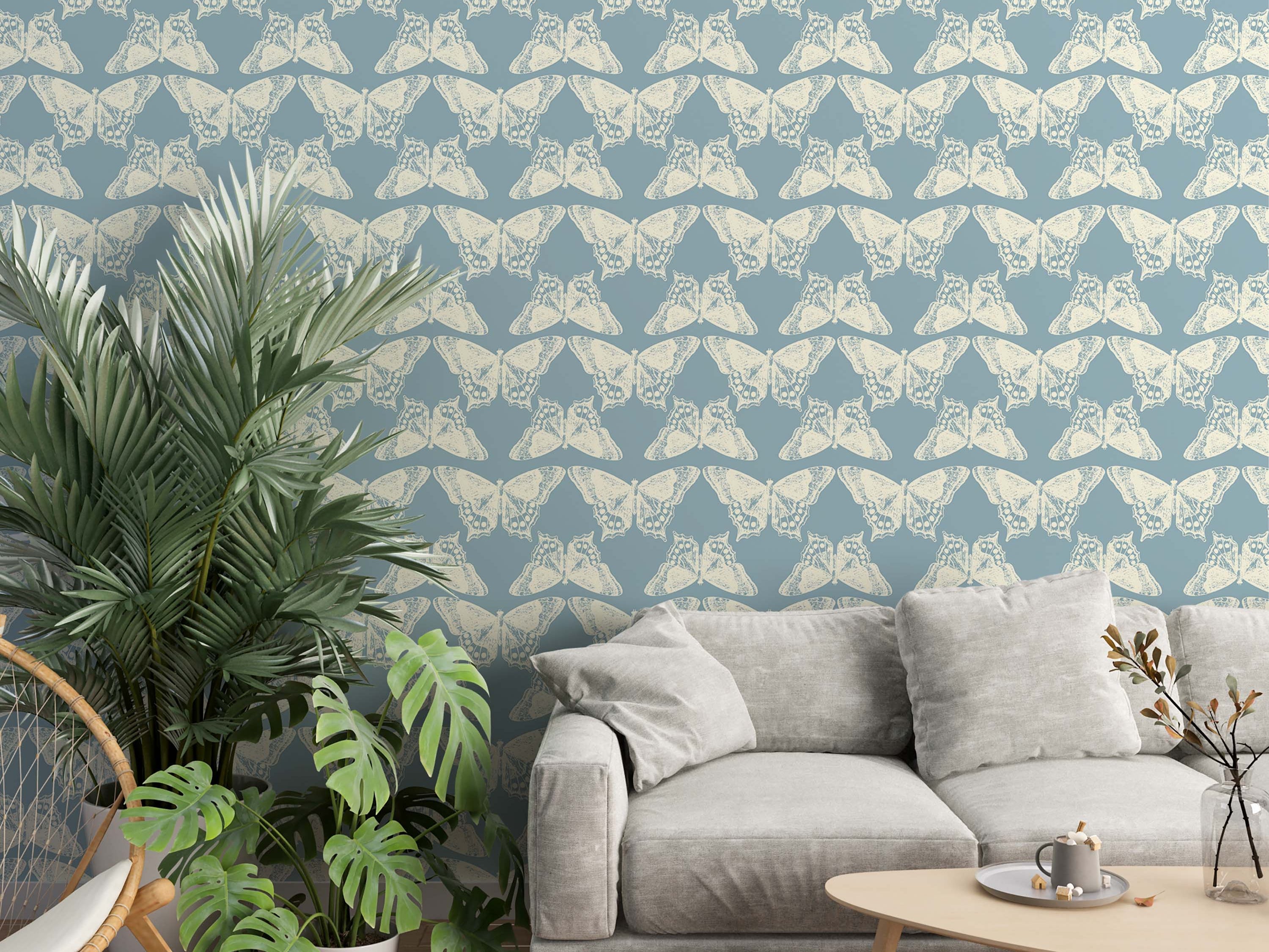 A repeating wallpaper pattern of illustrative, off-white butterflies arranged in rows on a dusty blue background.