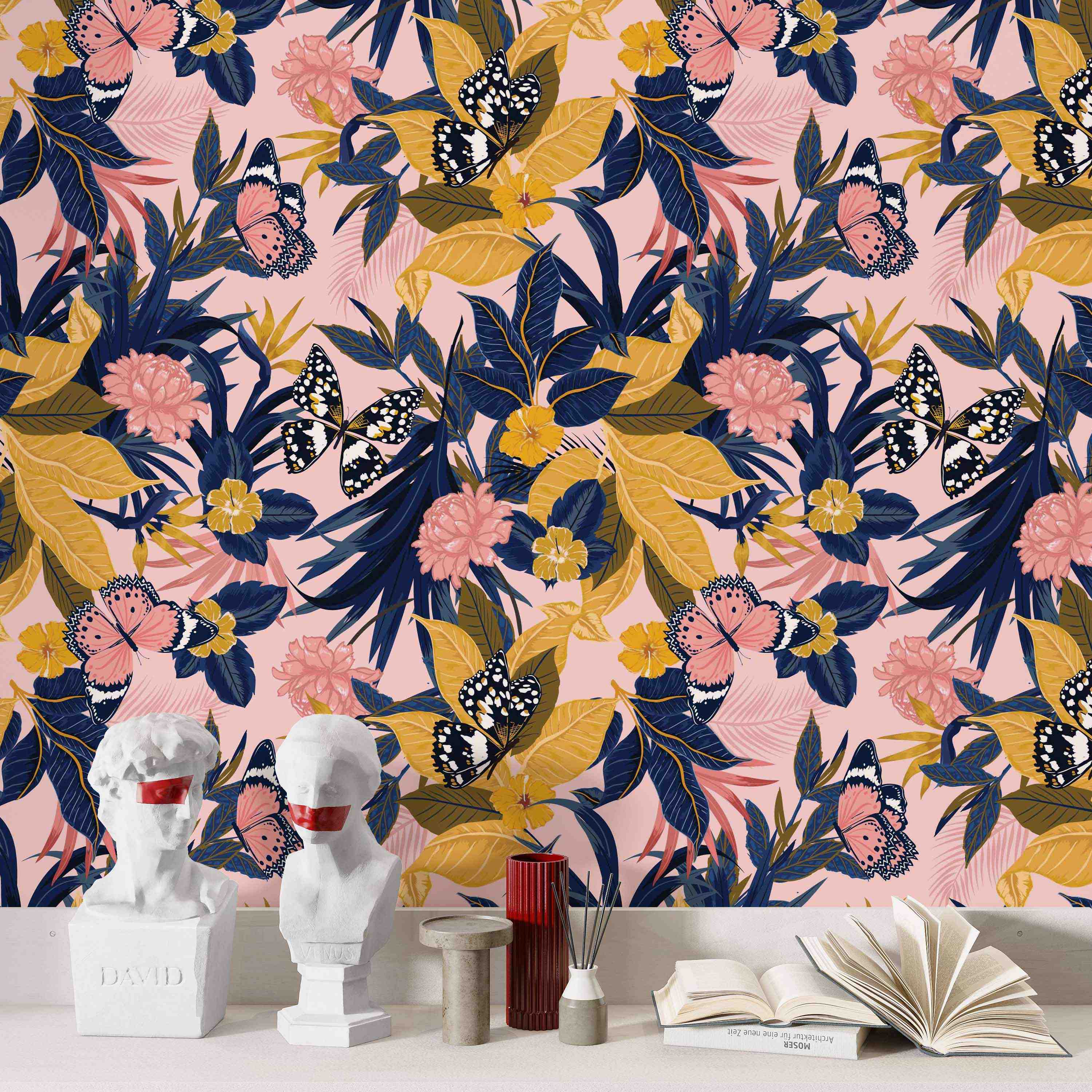 Wallpaper featuring pink and black butterflies, tropical blue and yellow leaves, and pink flowers on a light pink background.