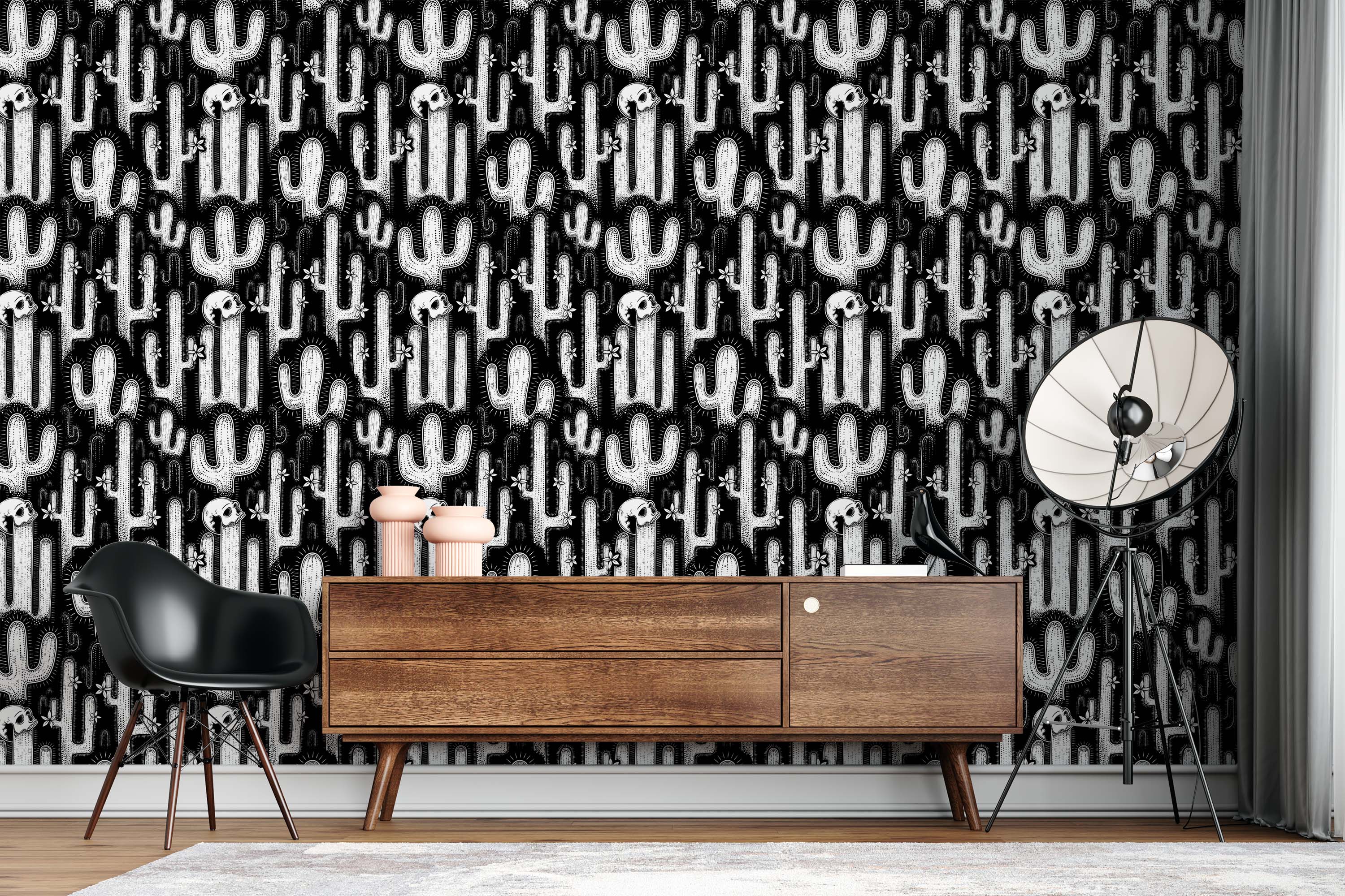 A black and white wallpaper featuring a repeating pattern of illustrated cacti, skulls, and small flowers in a graphic style.