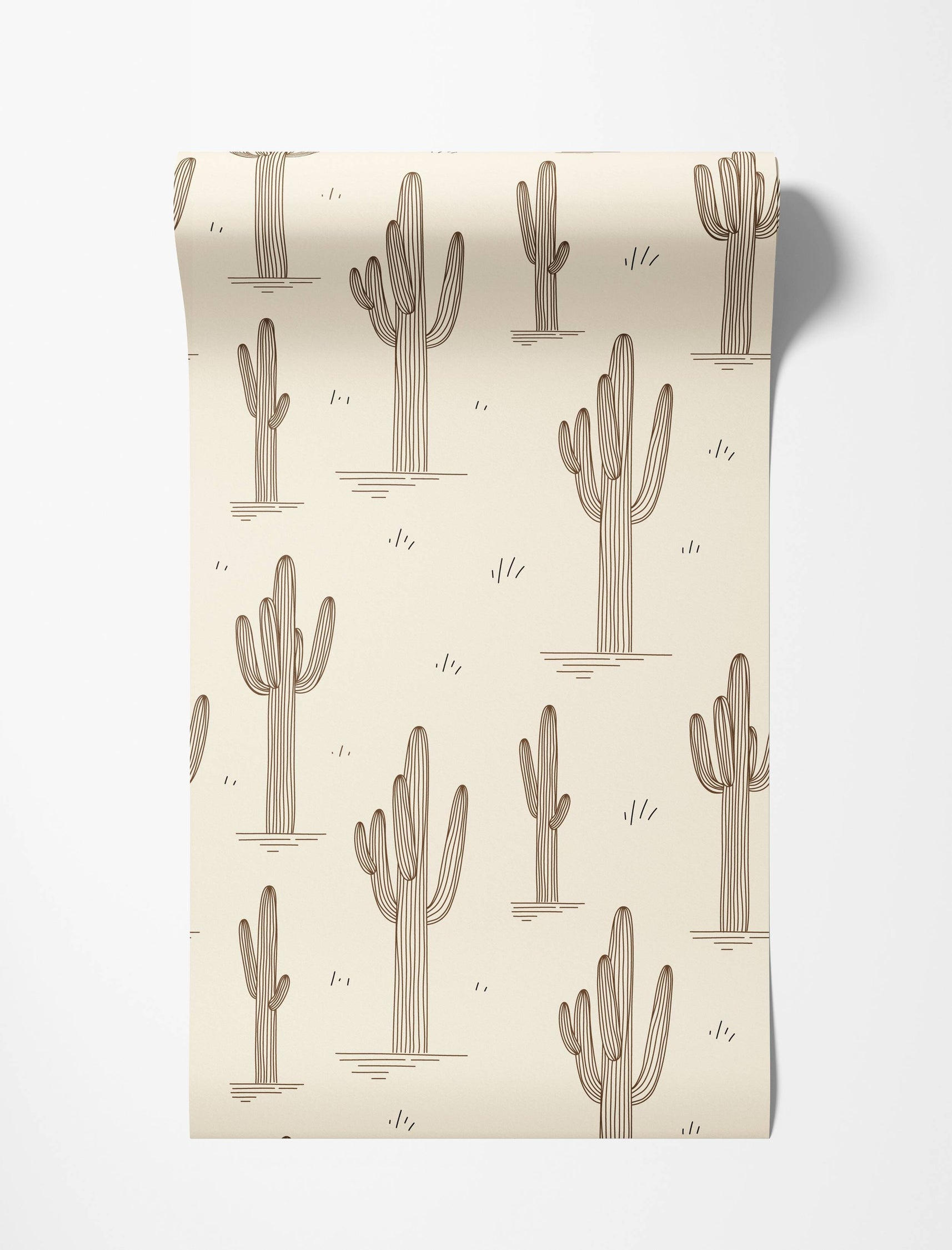 Beige wallpaper with a repeating pattern of brown line-art saguaro cacti and small accent dashes, creating a desert motif.