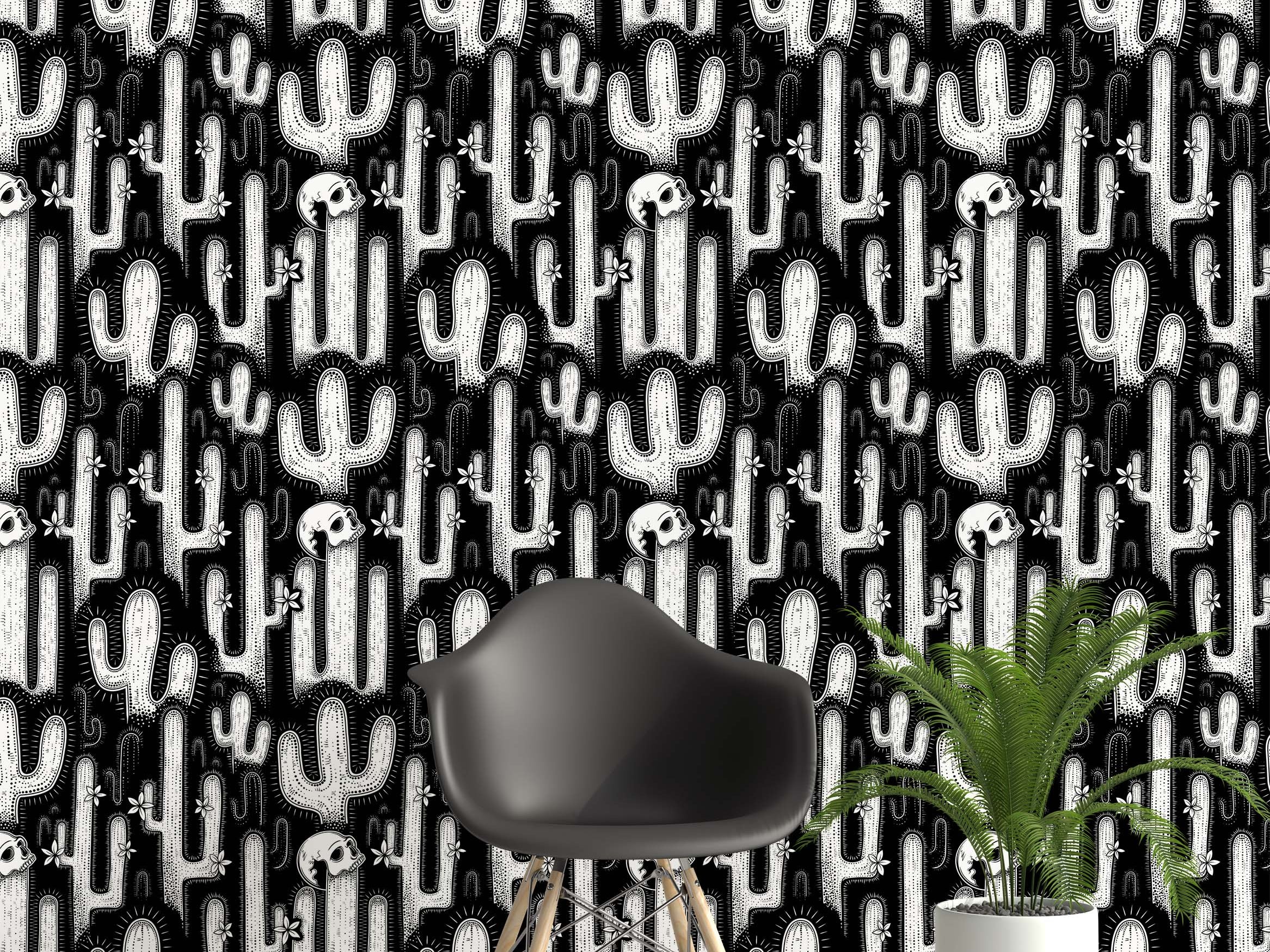 A graphic wallpaper with a linocut-style pattern of white cacti, skulls, and flowers on a solid black background.