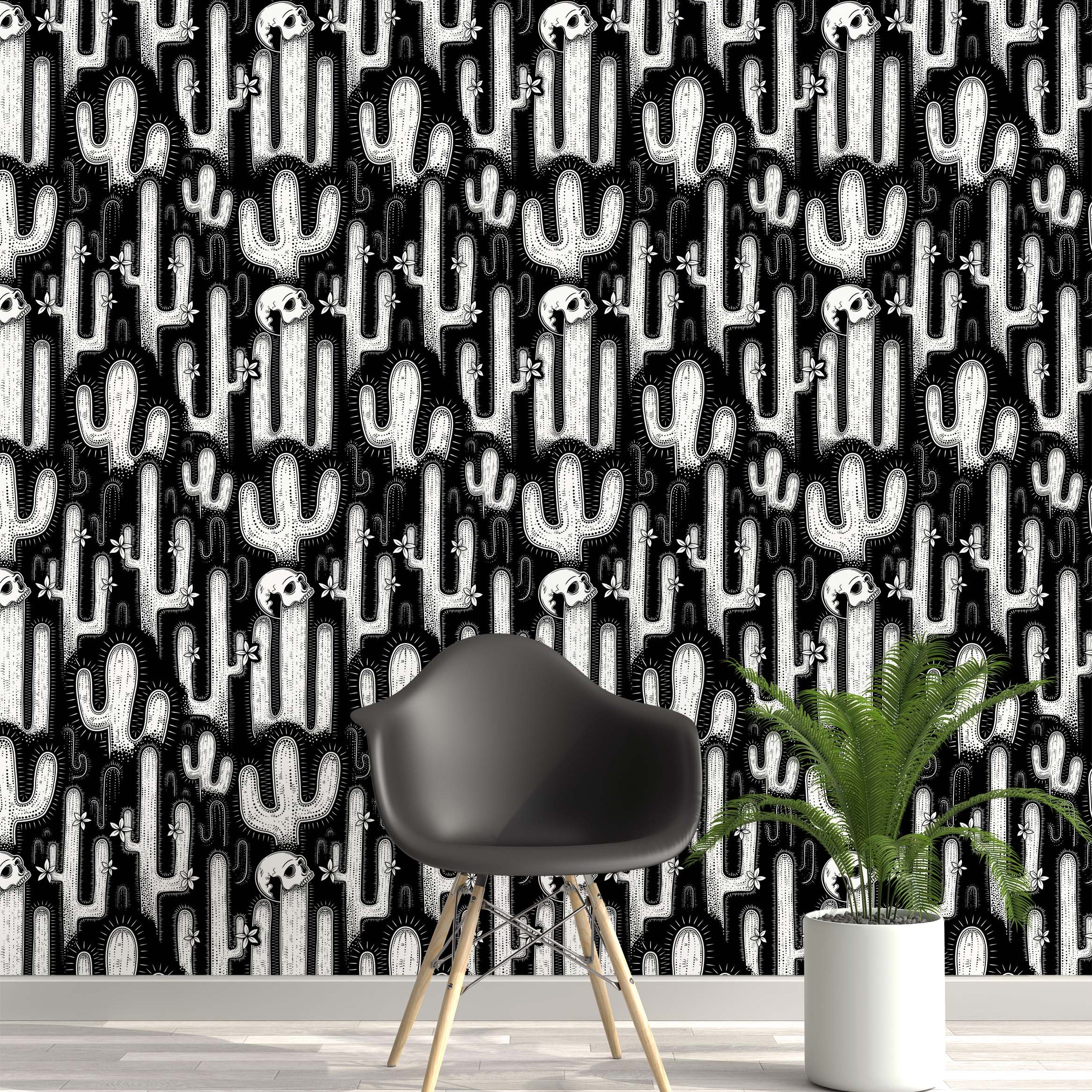 A graphic wallpaper with a linocut-style pattern of white cacti, skulls, and flowers on a solid black background.