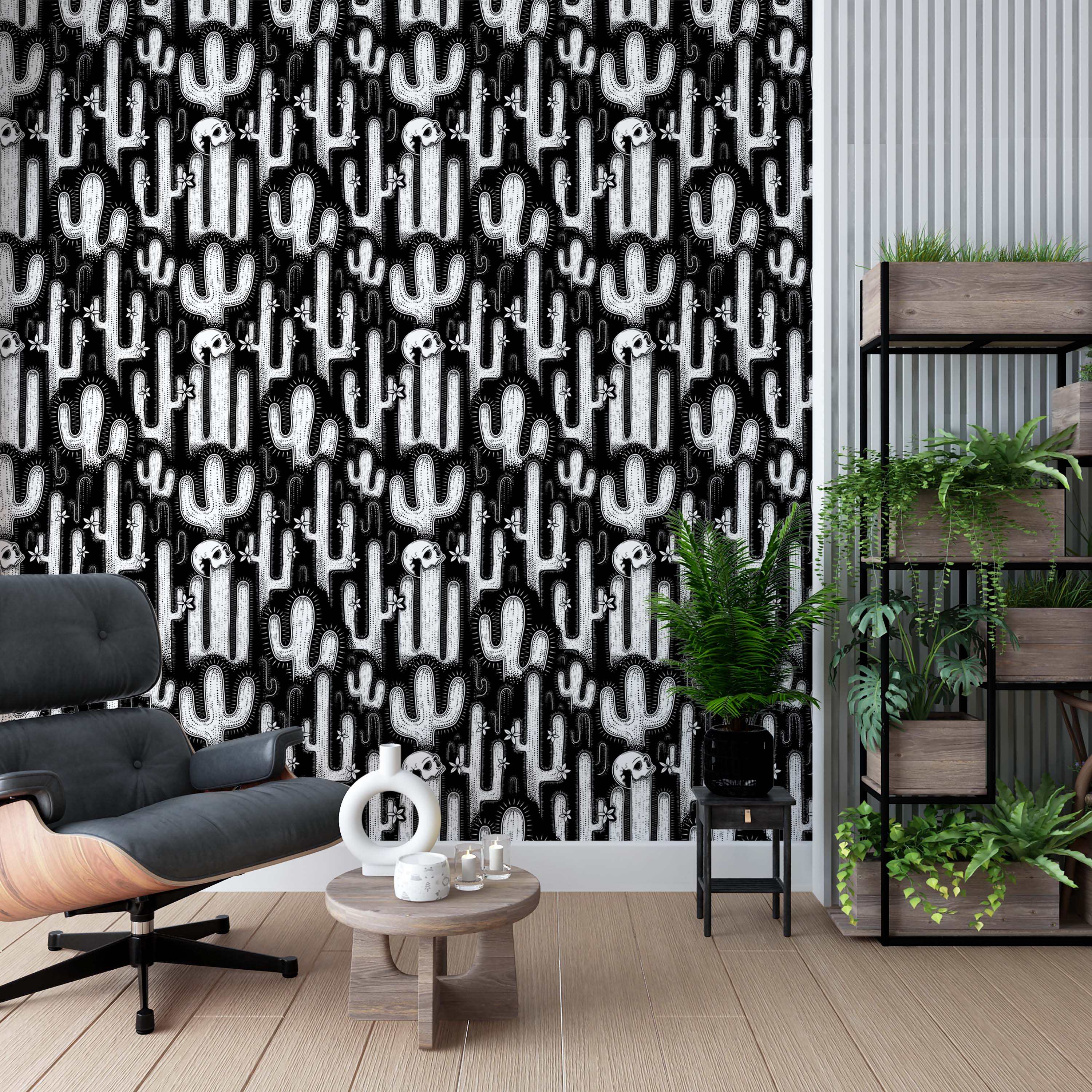 A black and white wallpaper with a repeating pattern of illustrative cacti, flowers, and skulls on a black background.