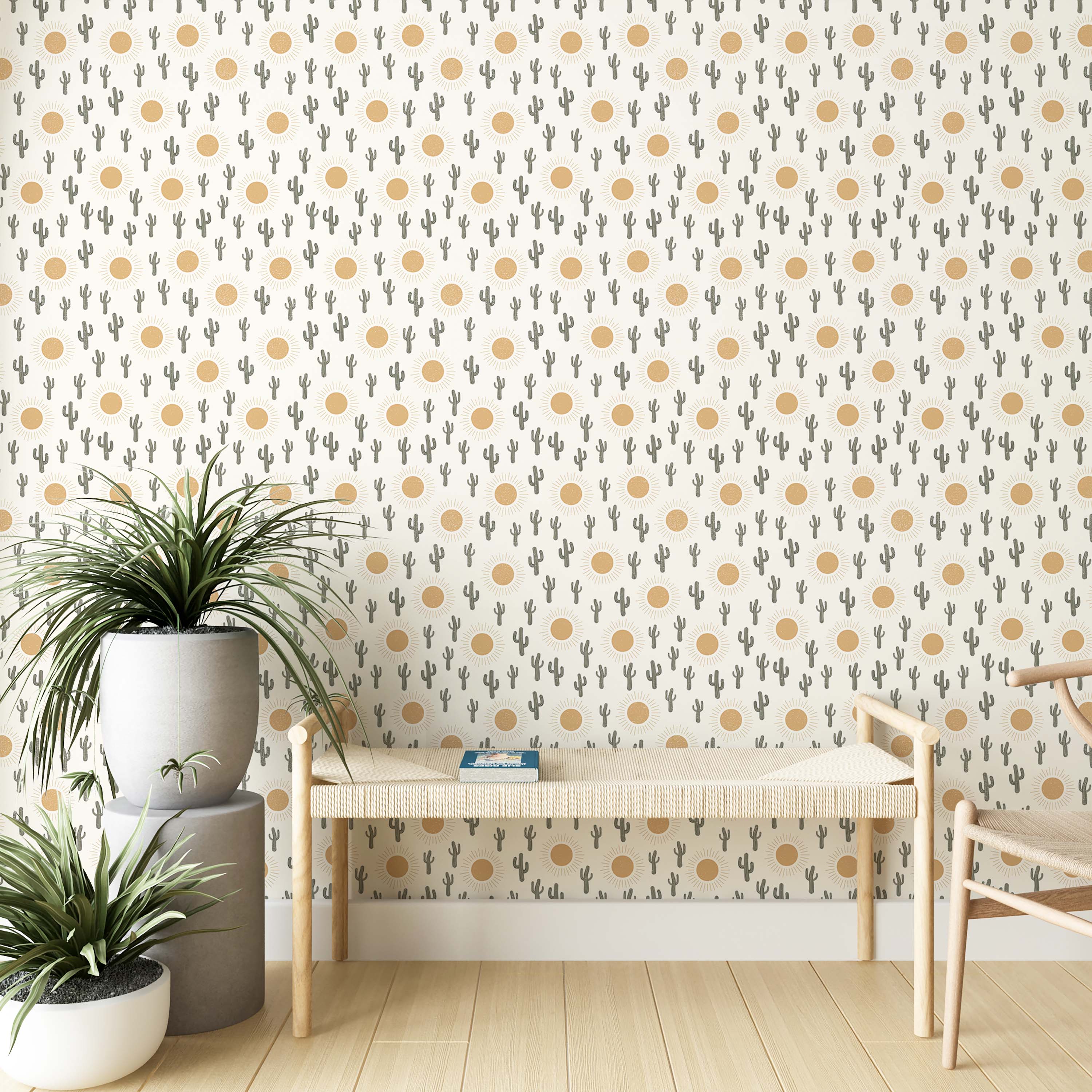 A whimsical wallpaper with a repeating pattern of gray-green cacti and golden-yellow suns on an off-white background.
