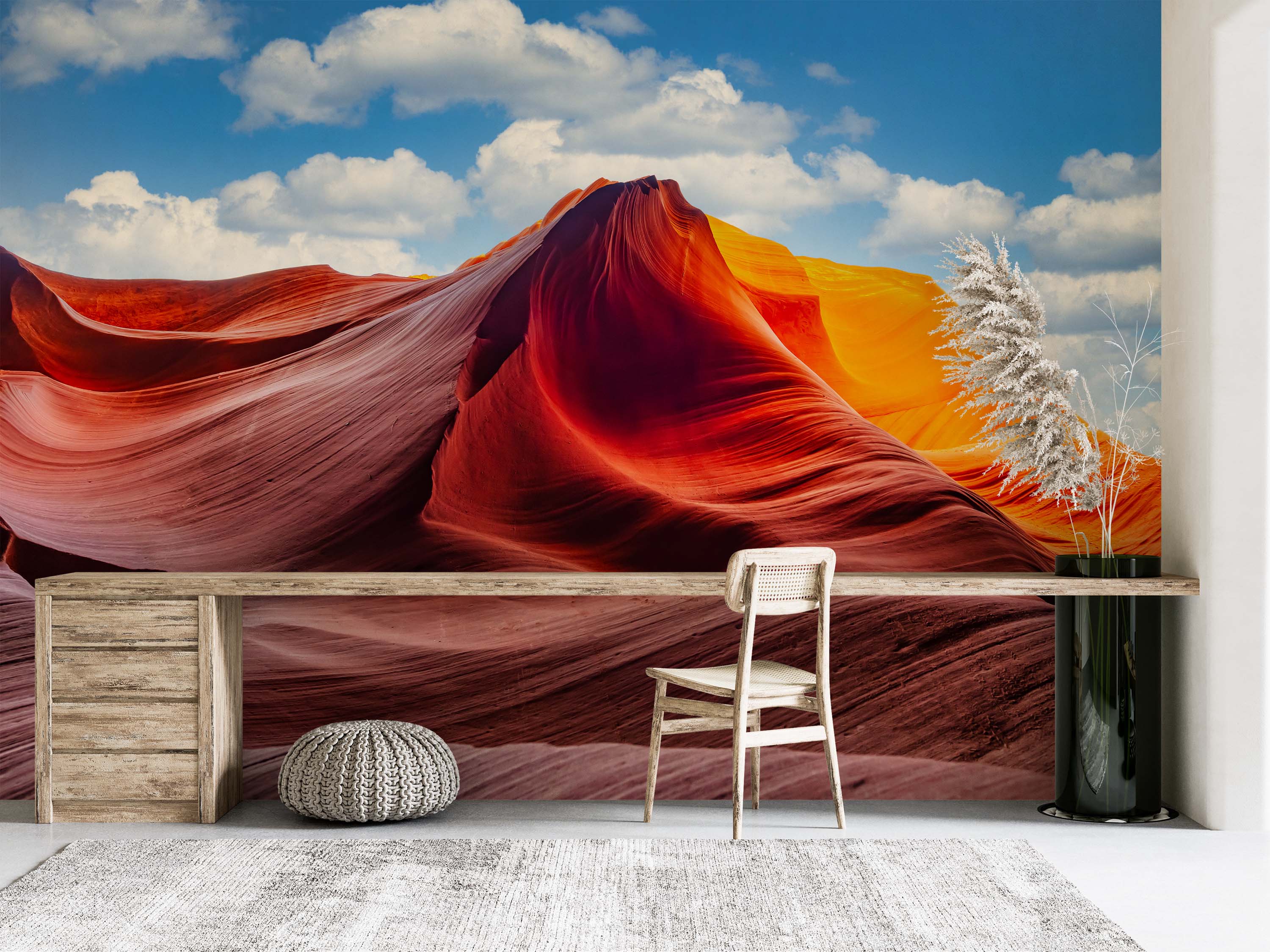 A photographic wall mural depicting a vibrant slot canyon with flowing red, orange, and yellow rock formations beneath a bright blue sky with white clouds.