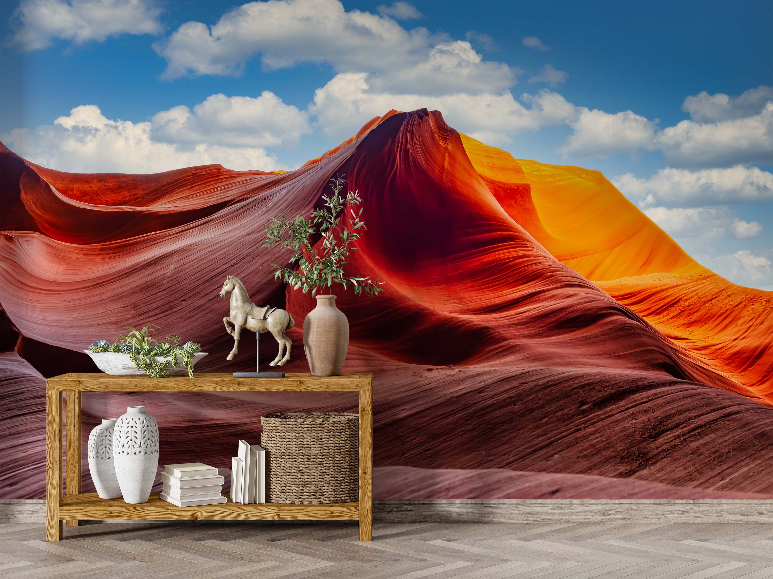 A wall mural of a sunlit slot canyon with wavy red and orange rock formations under a blue sky with clouds.