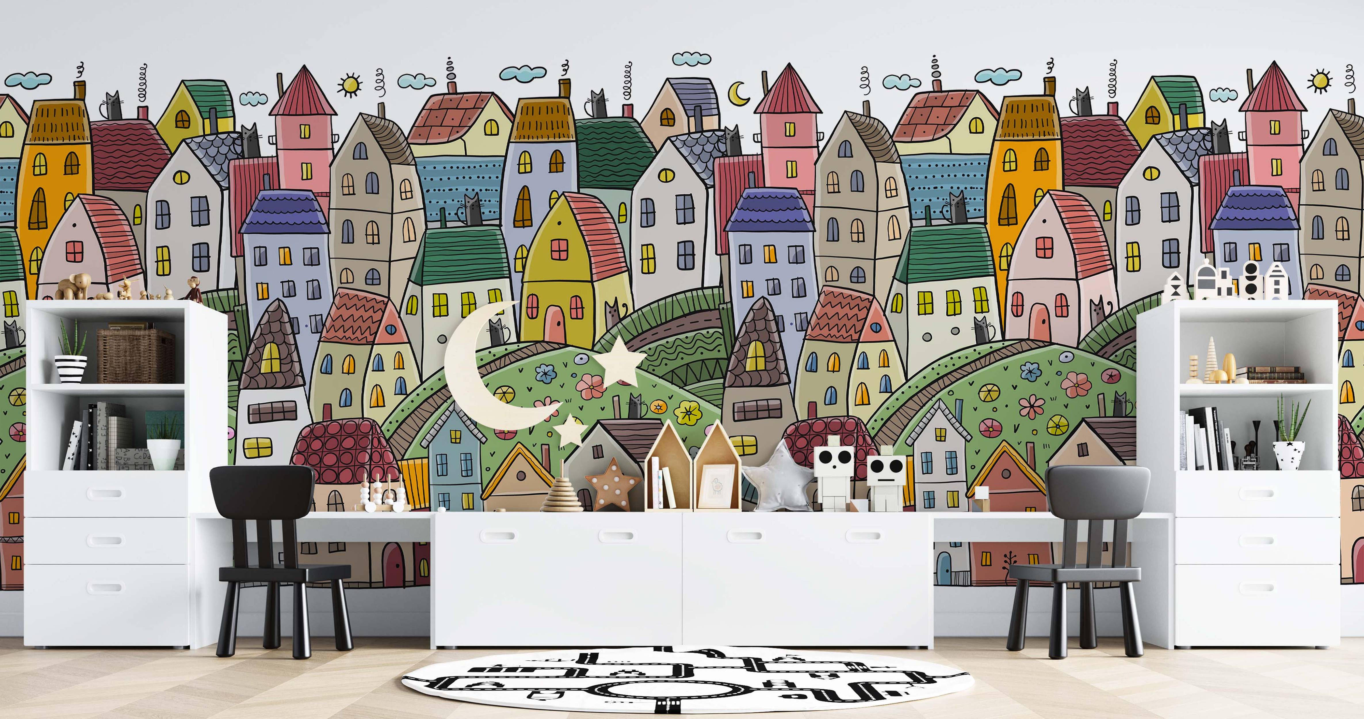 Colorful cartoon cityscape mural featuring whimsical houses, cats, clouds, and a moon in a hand-drawn style.