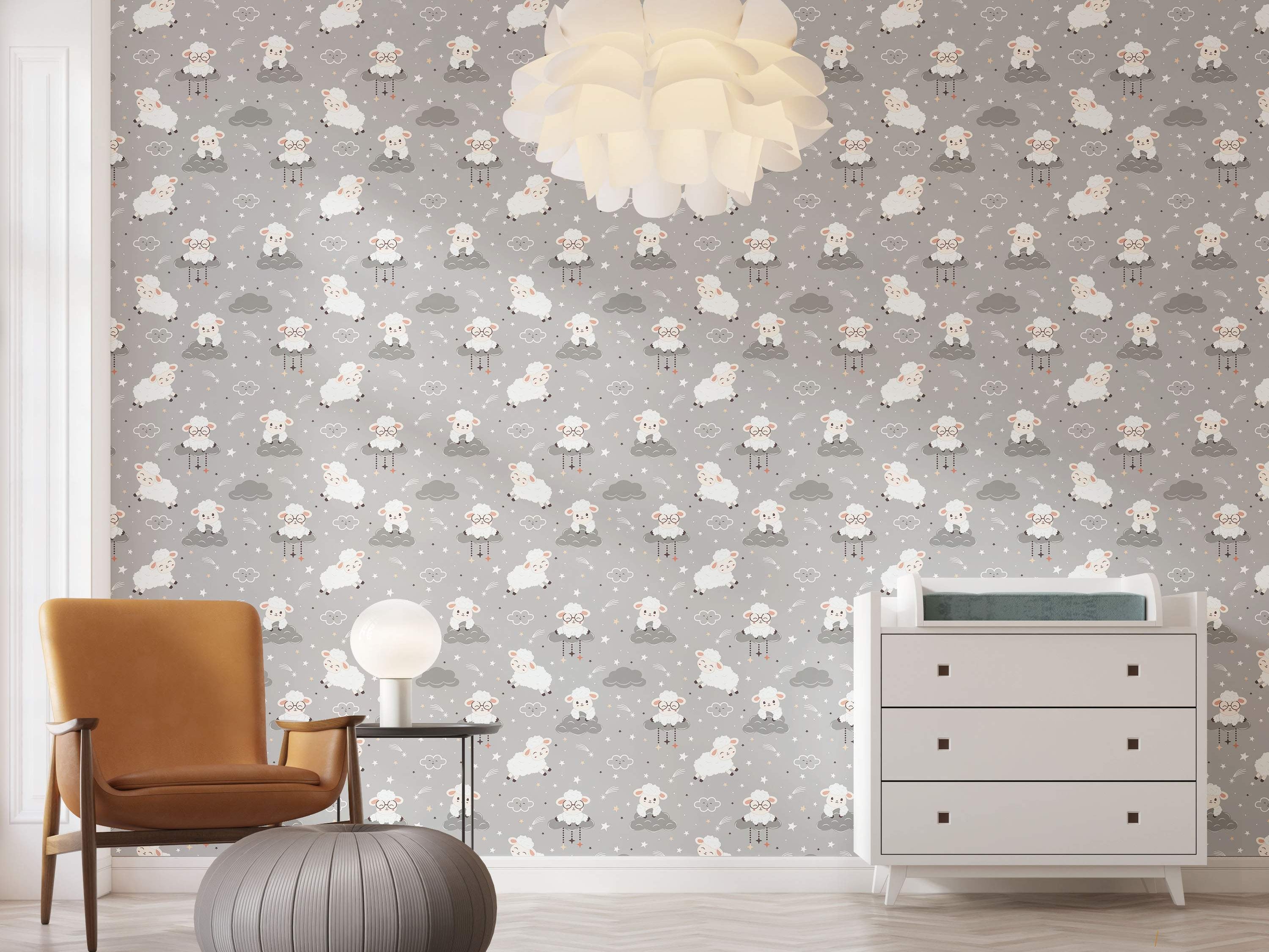 Gray wallpaper with a repeating pattern of cartoon sheep on clouds, jumping sheep, stars, and shooting stars in white and gray.