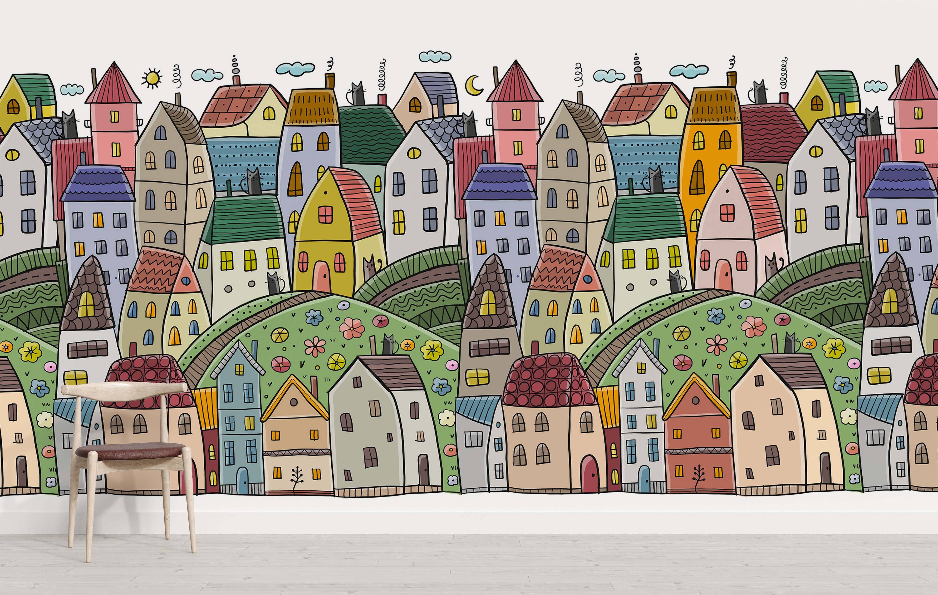 Whimsical cartoon village wallpaper with colorful houses, rolling hills, cats, sun, and moon in a hand-drawn style.