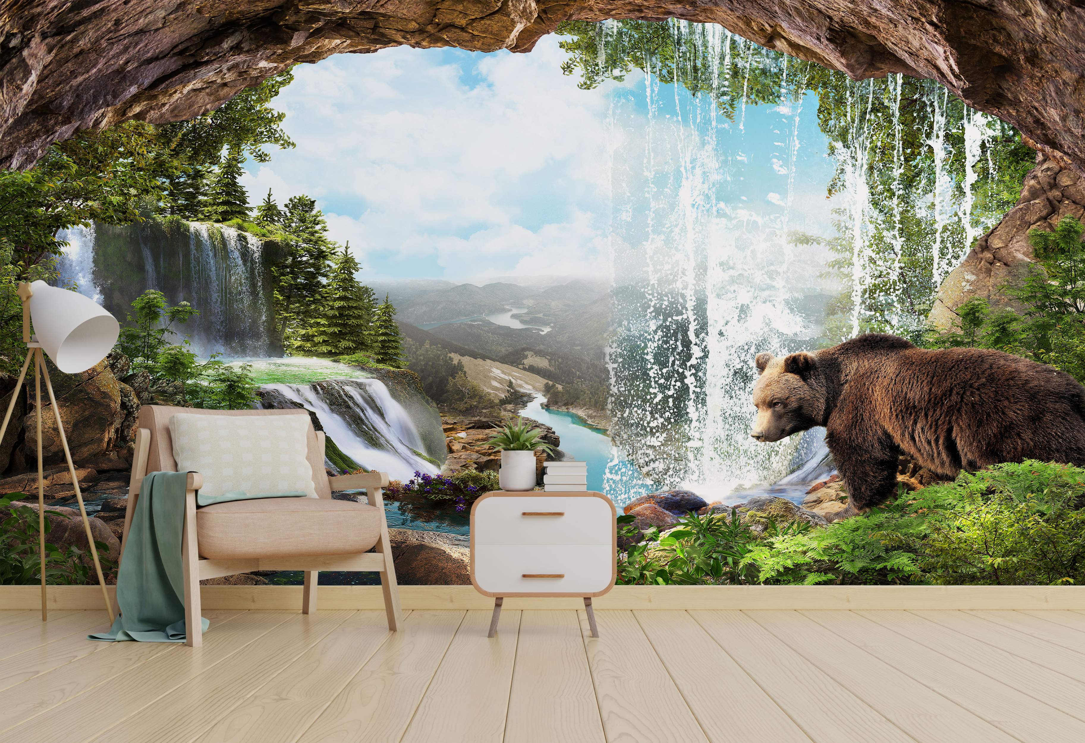 Mural depicting a cave opening onto a scenic landscape with waterfalls, mountains, a river, green trees, and a brown bear.