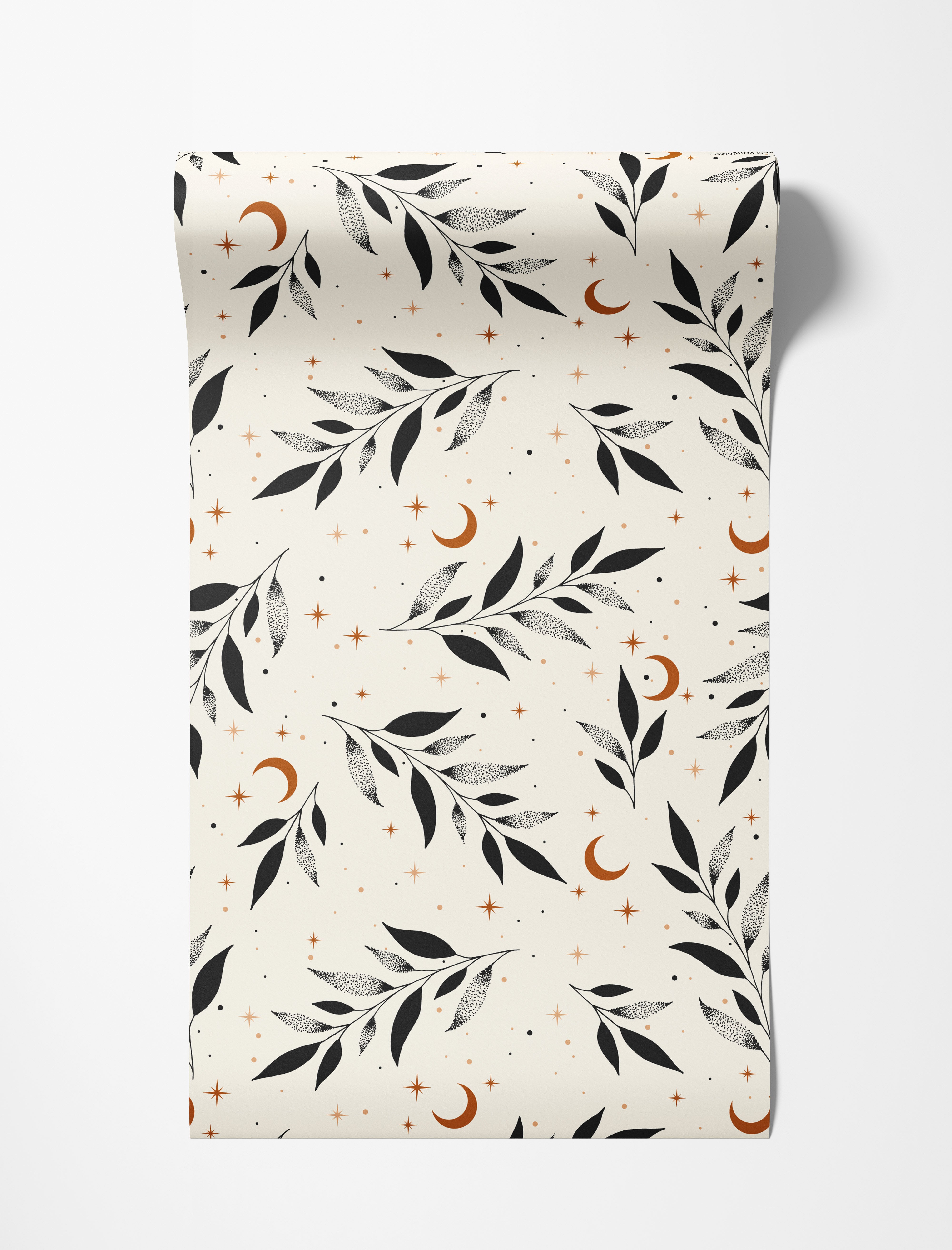 A celestial wallpaper with black stippled leaves, rust-colored crescent moons, and stars on a cream background.