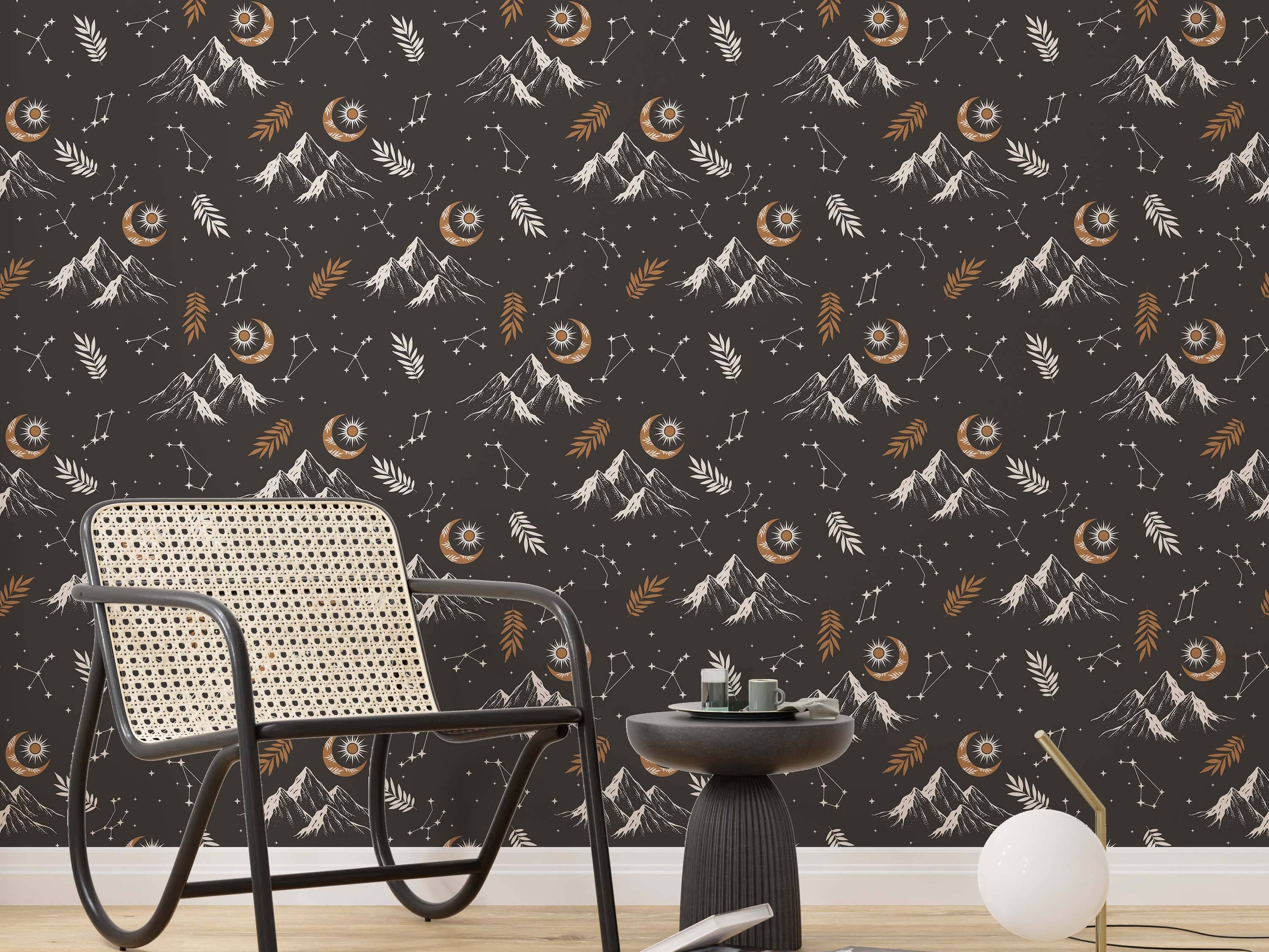 Wallpaper with a celestial mountain theme featuring white and gold moons, suns, stars, and leaves on a dark gray background.