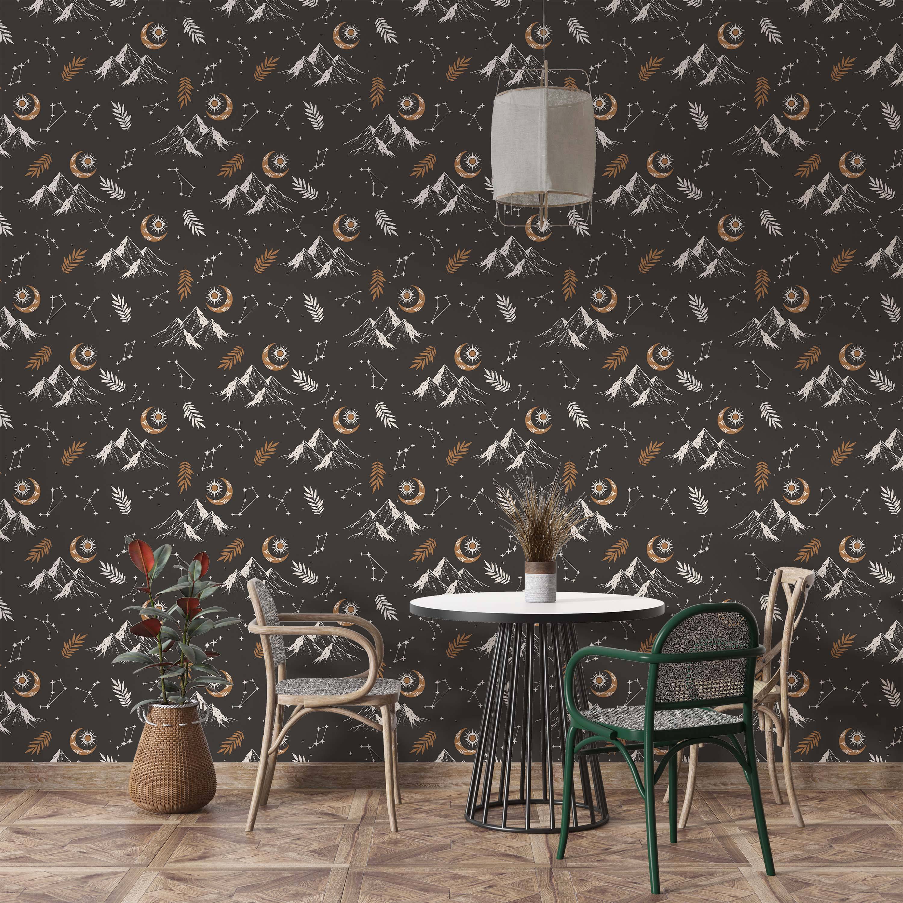 Dark gray wallpaper with a celestial pattern of white mountains, tan crescent moons with suns, white stars, and tan/white leaves.