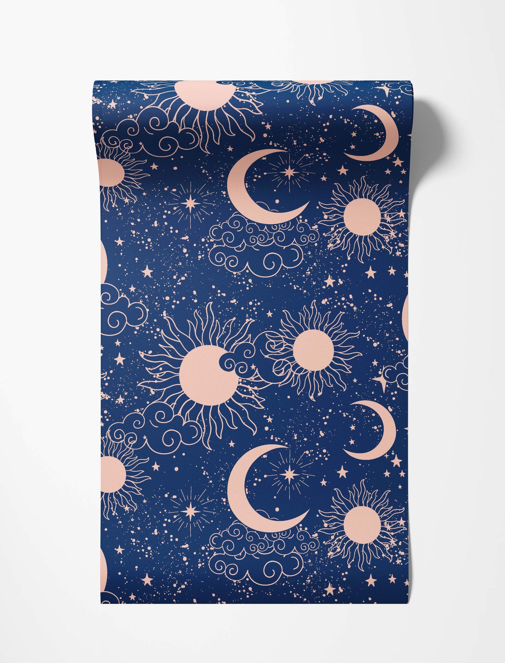 Celestial wallpaper with light pink suns, crescent moons, stars, and clouds on a speckled dark blue background.
