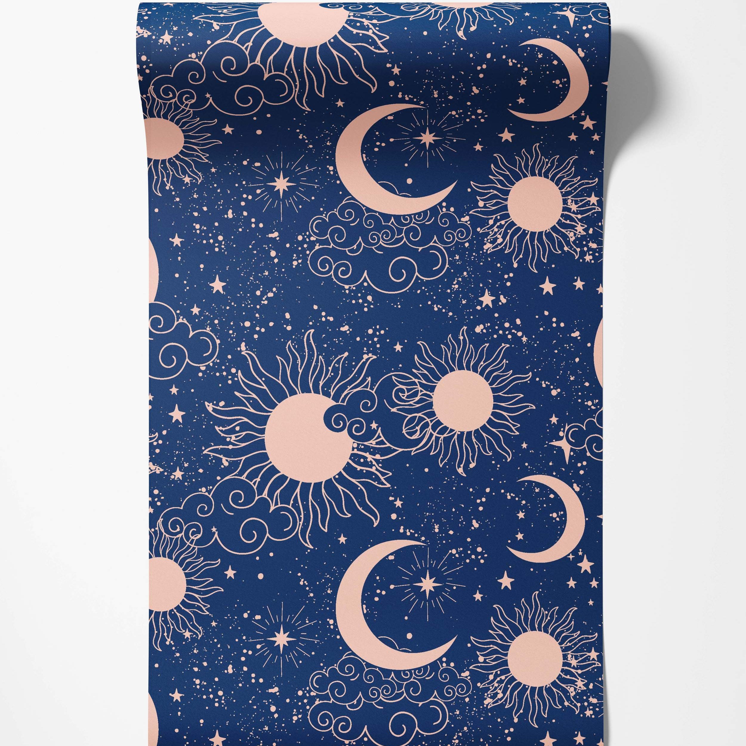 Celestial wallpaper with light pink suns, crescent moons, stars, and clouds on a speckled dark blue background.