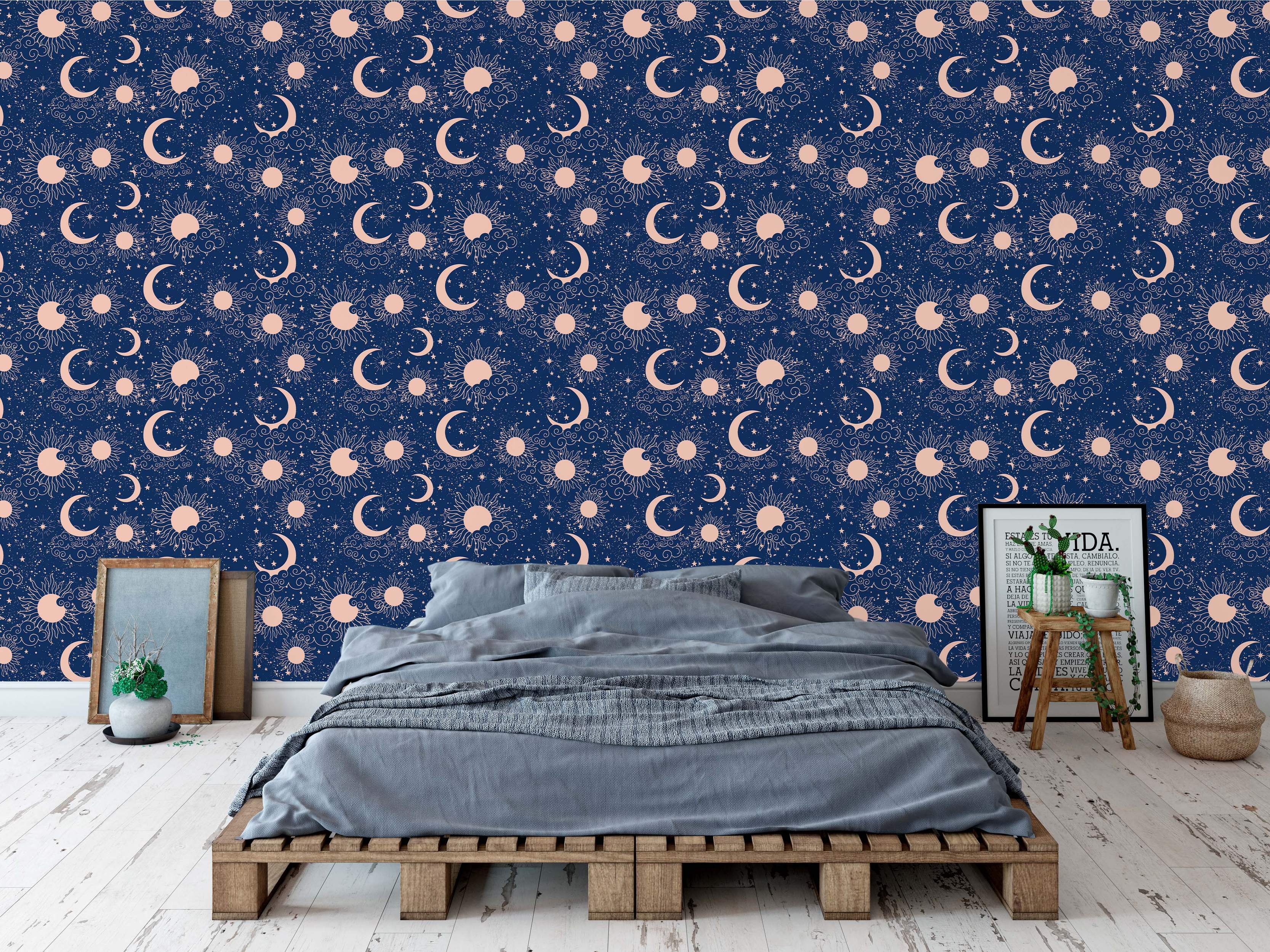 Navy blue wallpaper featuring a celestial pattern with pink stylized suns, crescent moons, stars, and clouds.