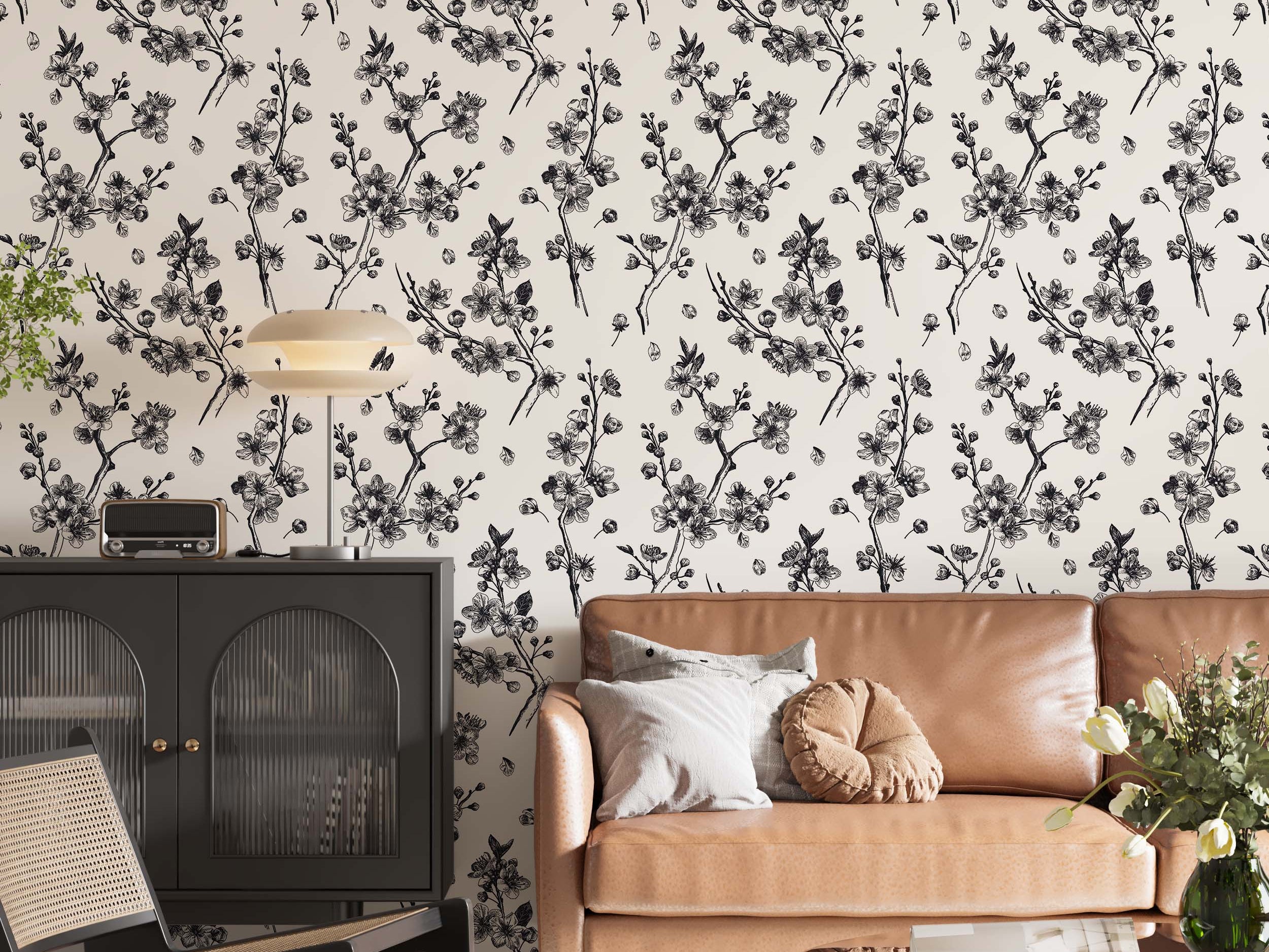 Wallpaper featuring black sketch-style cherry blossom branches and petals scattered across a cream background.