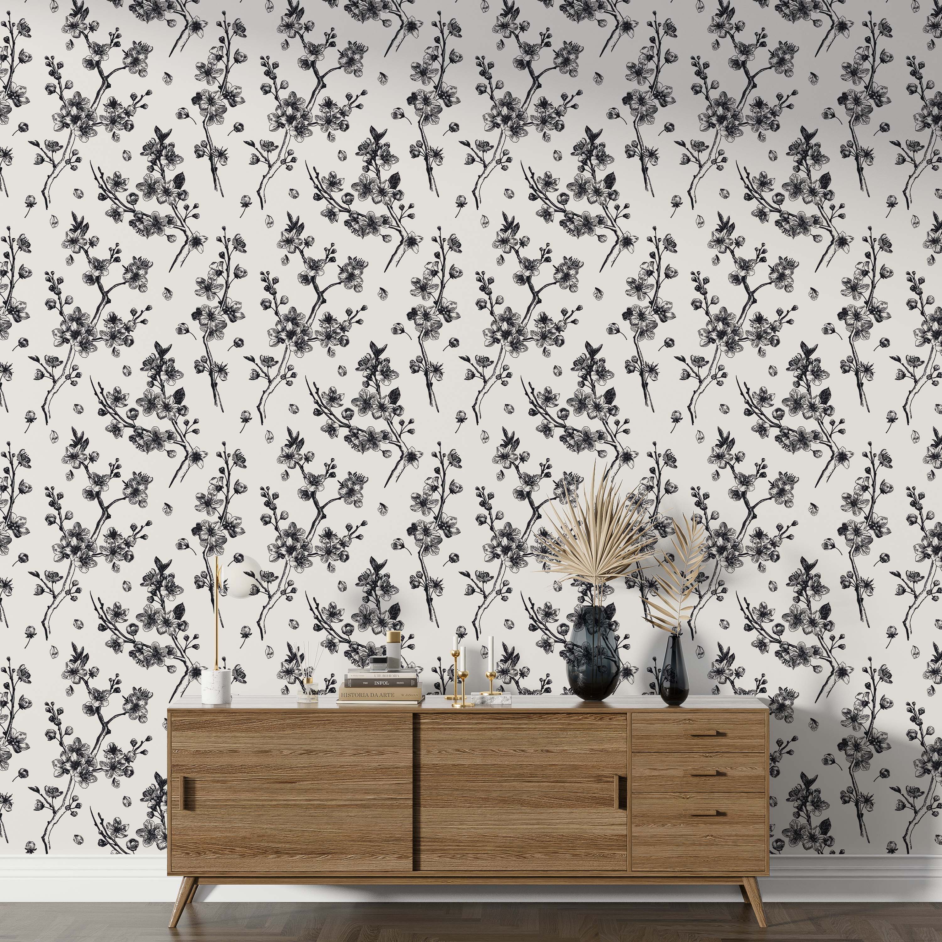 Repeating wallpaper pattern featuring black sketched cherry blossom branches, flowers, and petals on an off-white background.