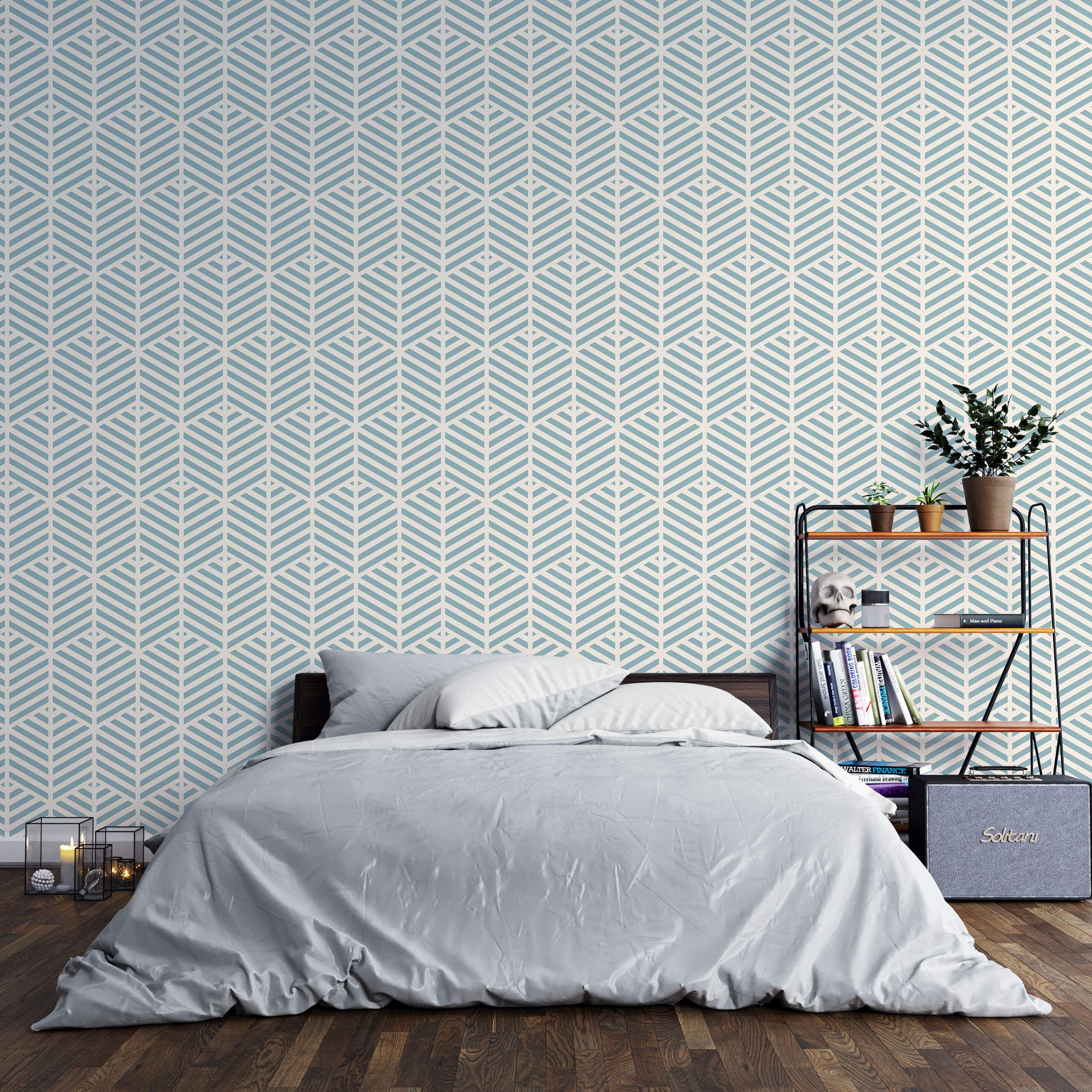 Geometric wallpaper with repeating stylized leaf shapes formed by light blue chevron stripes on a cream background.