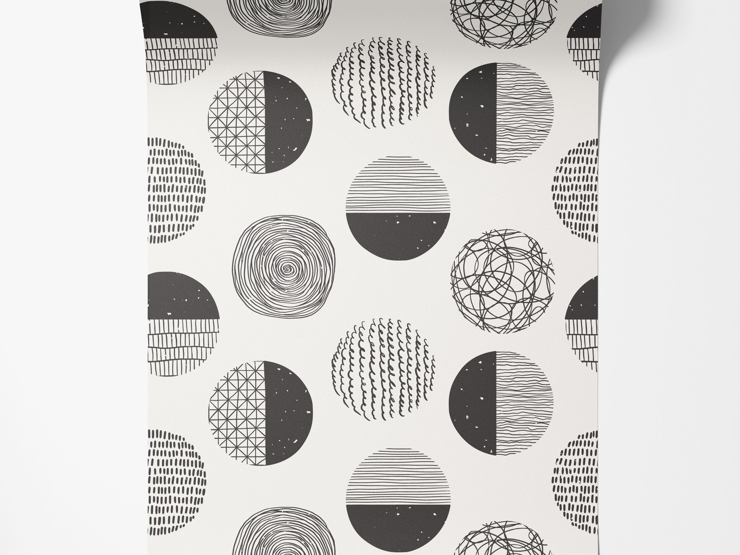 Wallpaper with a repeating pattern of abstract black and white circles, each filled with unique hand-drawn textures.