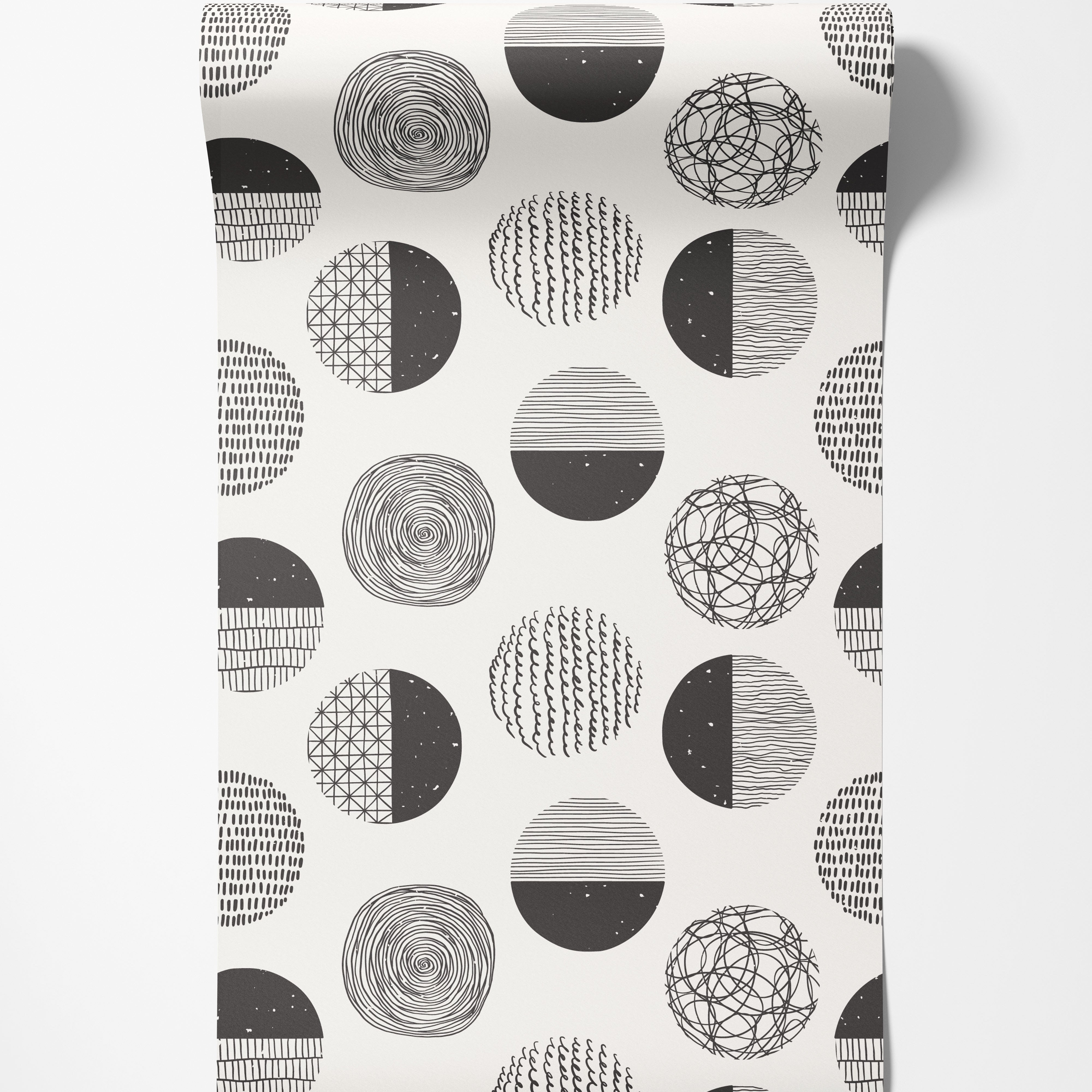 Wallpaper with a repeating pattern of abstract black and white circles, each filled with unique hand-drawn textures.