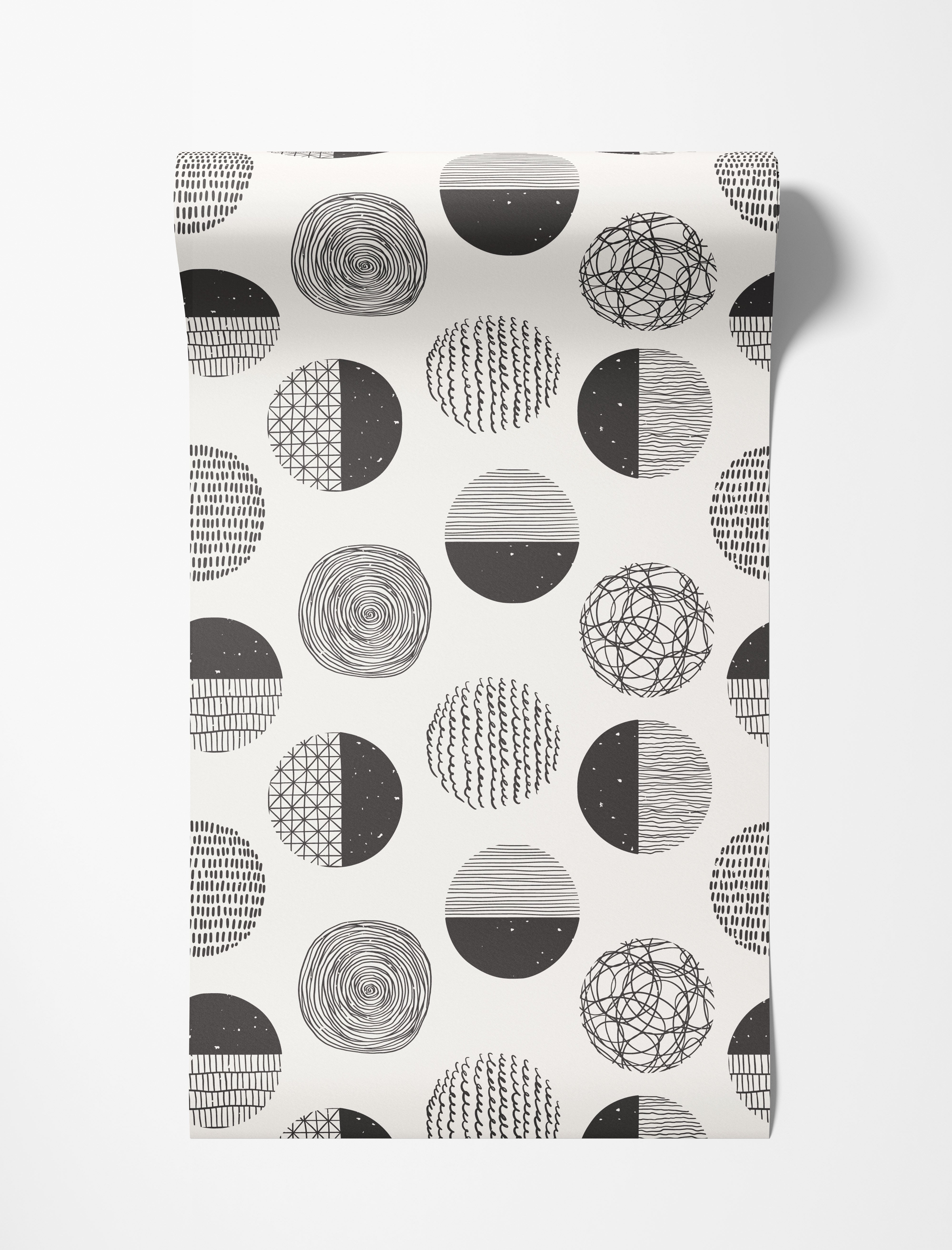 Wallpaper with a repeating pattern of abstract black and white circles, each filled with unique hand-drawn textures.