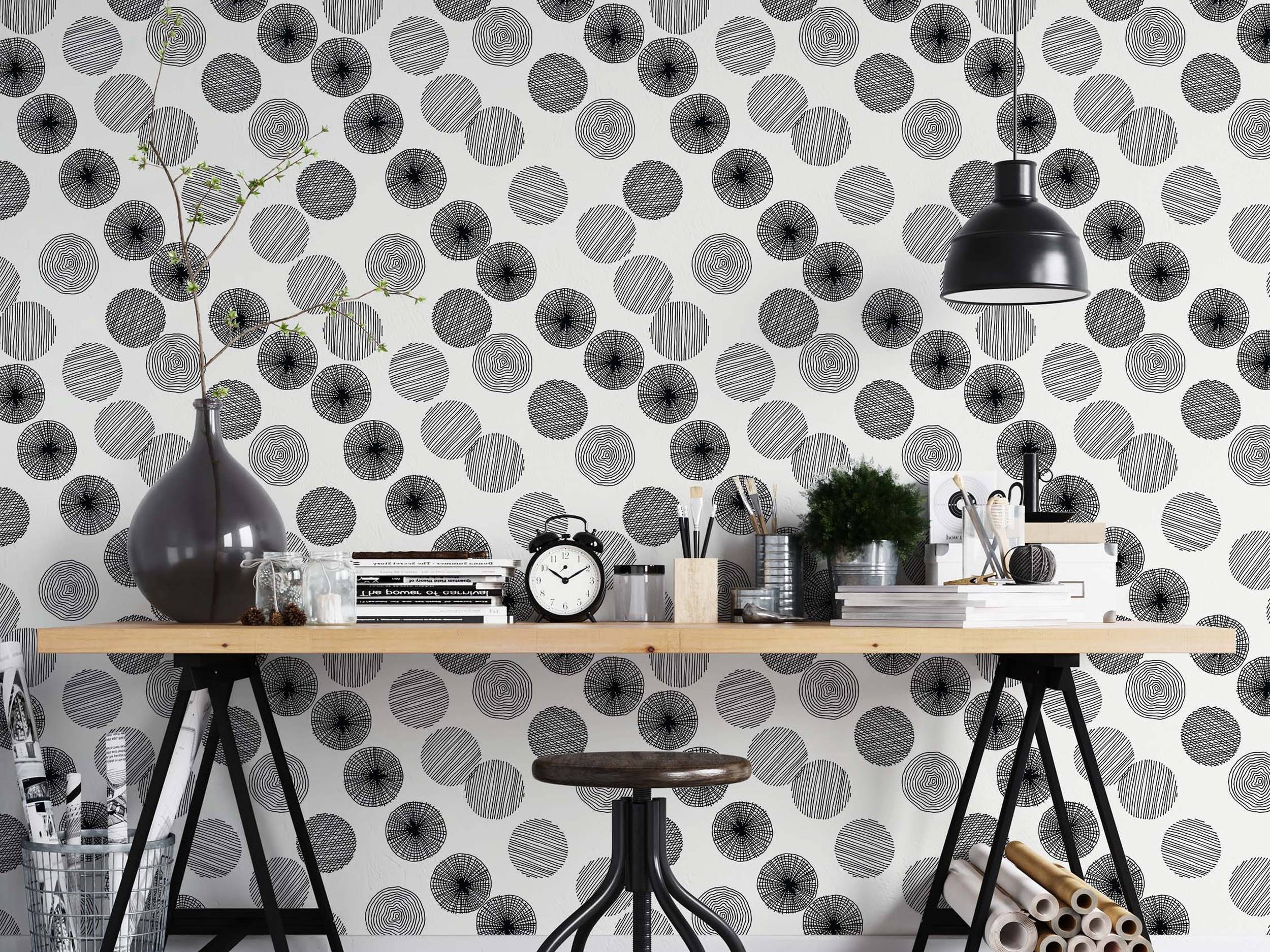 Wallpaper featuring black hand-drawn style circles with varied internal line patterns scattered across a white background.