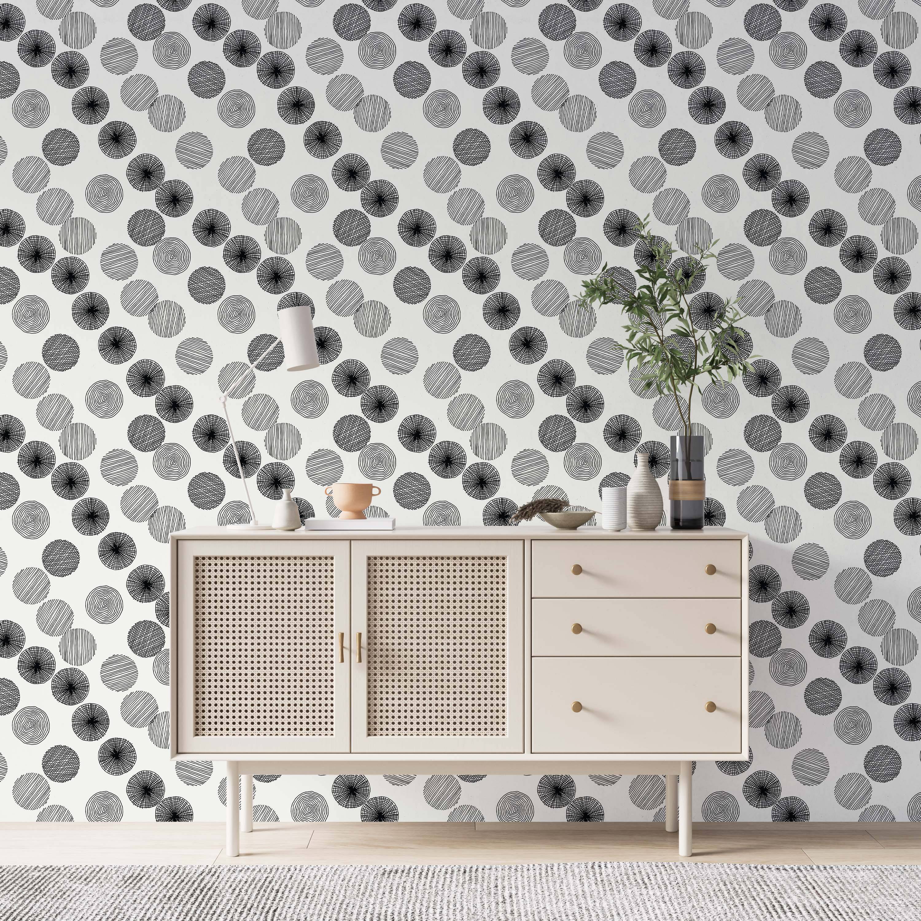Geometric wallpaper displaying various hand-drawn textured black circles randomly placed on a white field.
