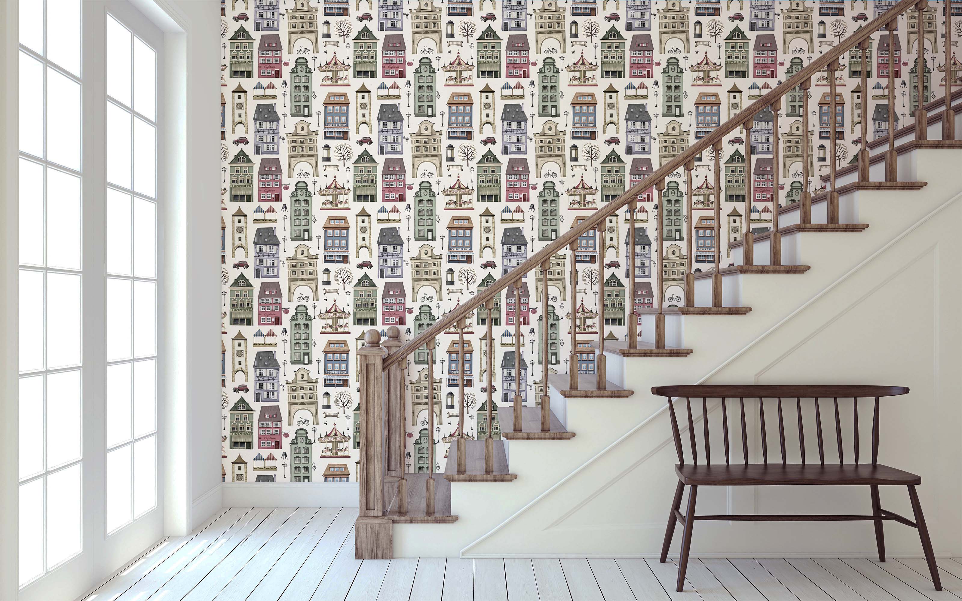 Whimsical cityscape wallpaper featuring illustrated buildings, cars, and carousels in muted green, blue, red, and beige tones.