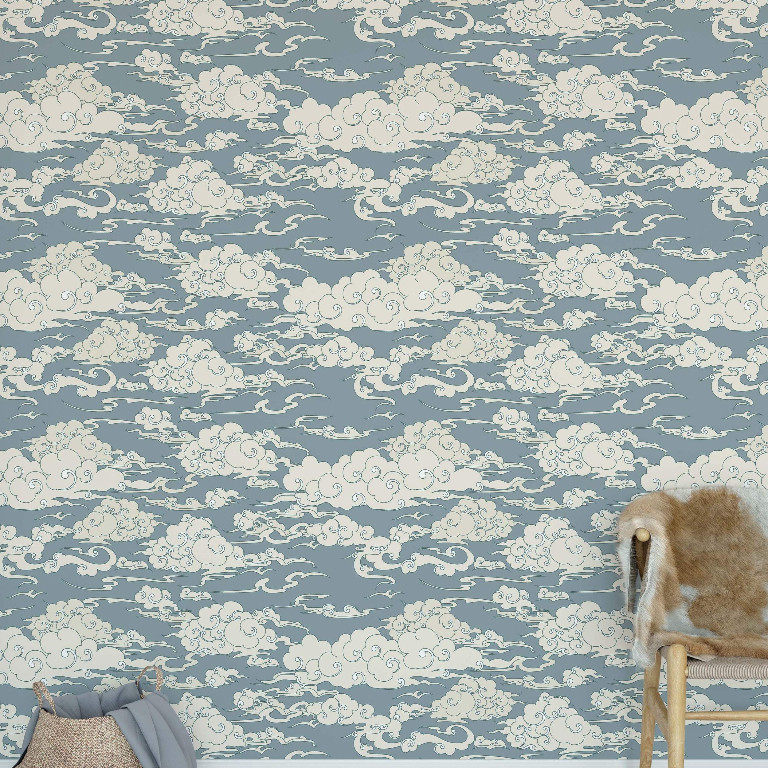 Blue-gray wallpaper with a repeating pattern of stylized cream clouds featuring swirling outlines.