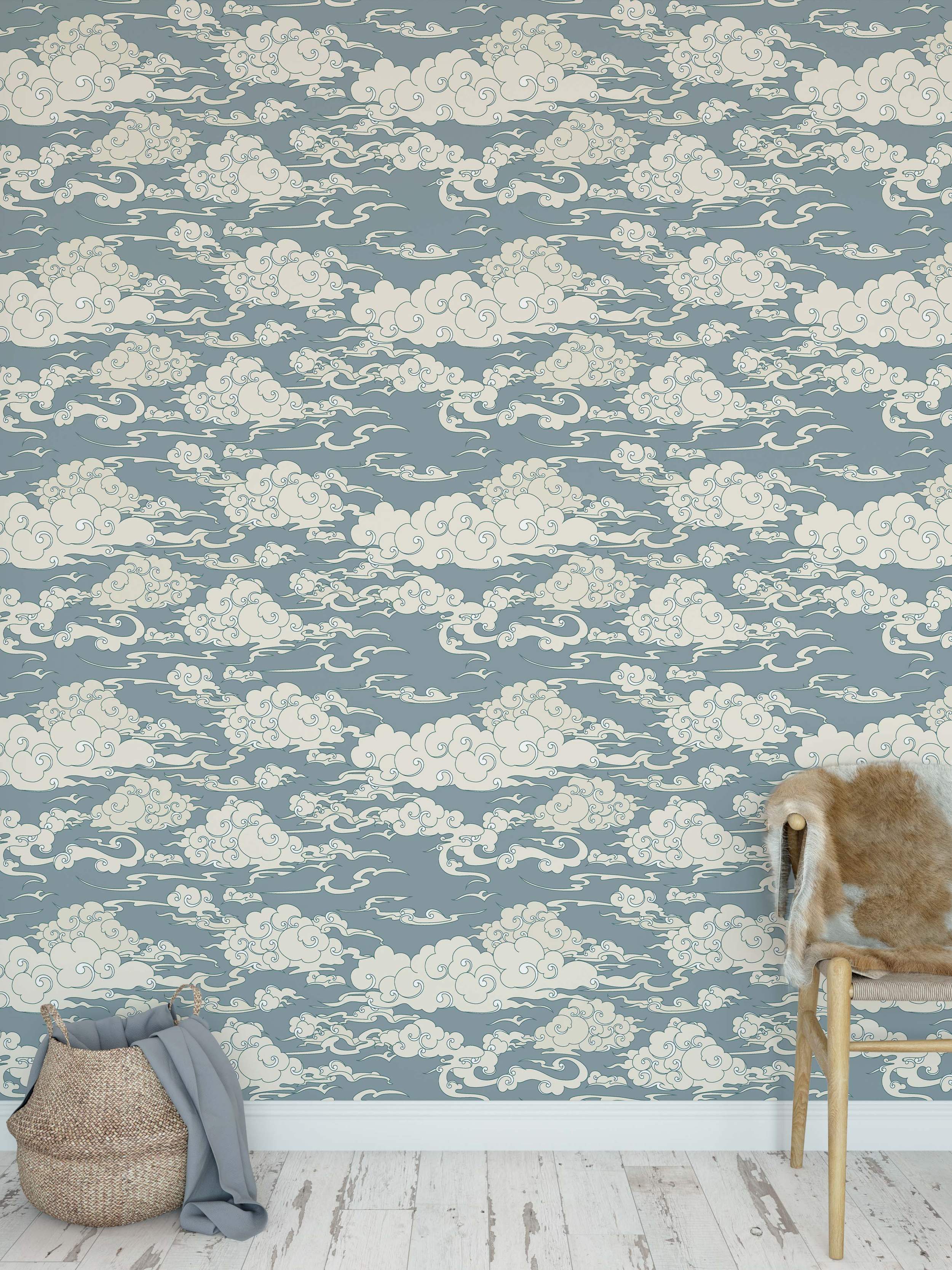 Blue-gray wallpaper with a repeating pattern of stylized cream clouds featuring swirling outlines.