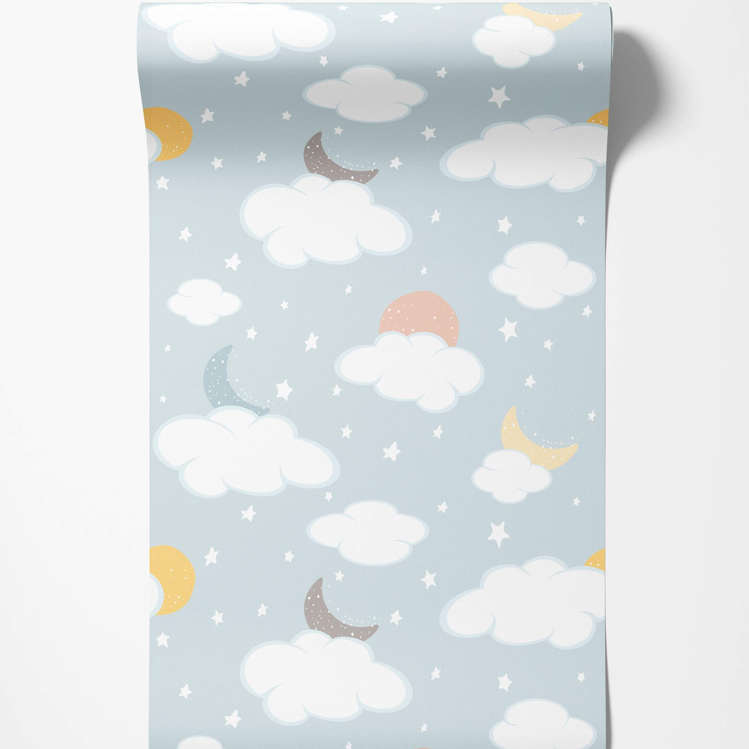 Children's wallpaper featuring white clouds, yellow, blue, and gray crescent moons, peach suns, and stars on a light blue sky.