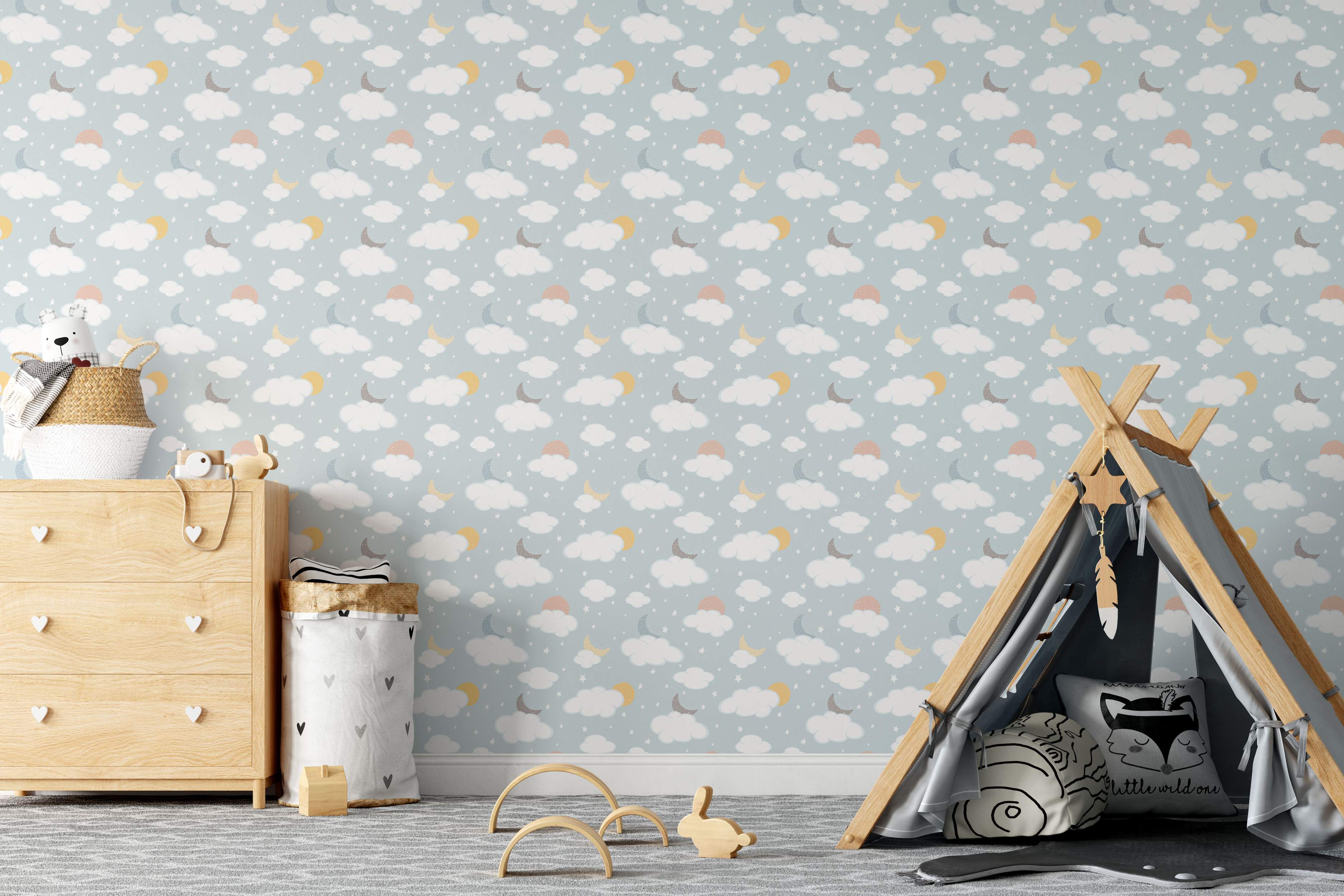 Children's sky wallpaper with white clouds, yellow, gray, and blue crescent moons, suns, and stars on a pale blue field.