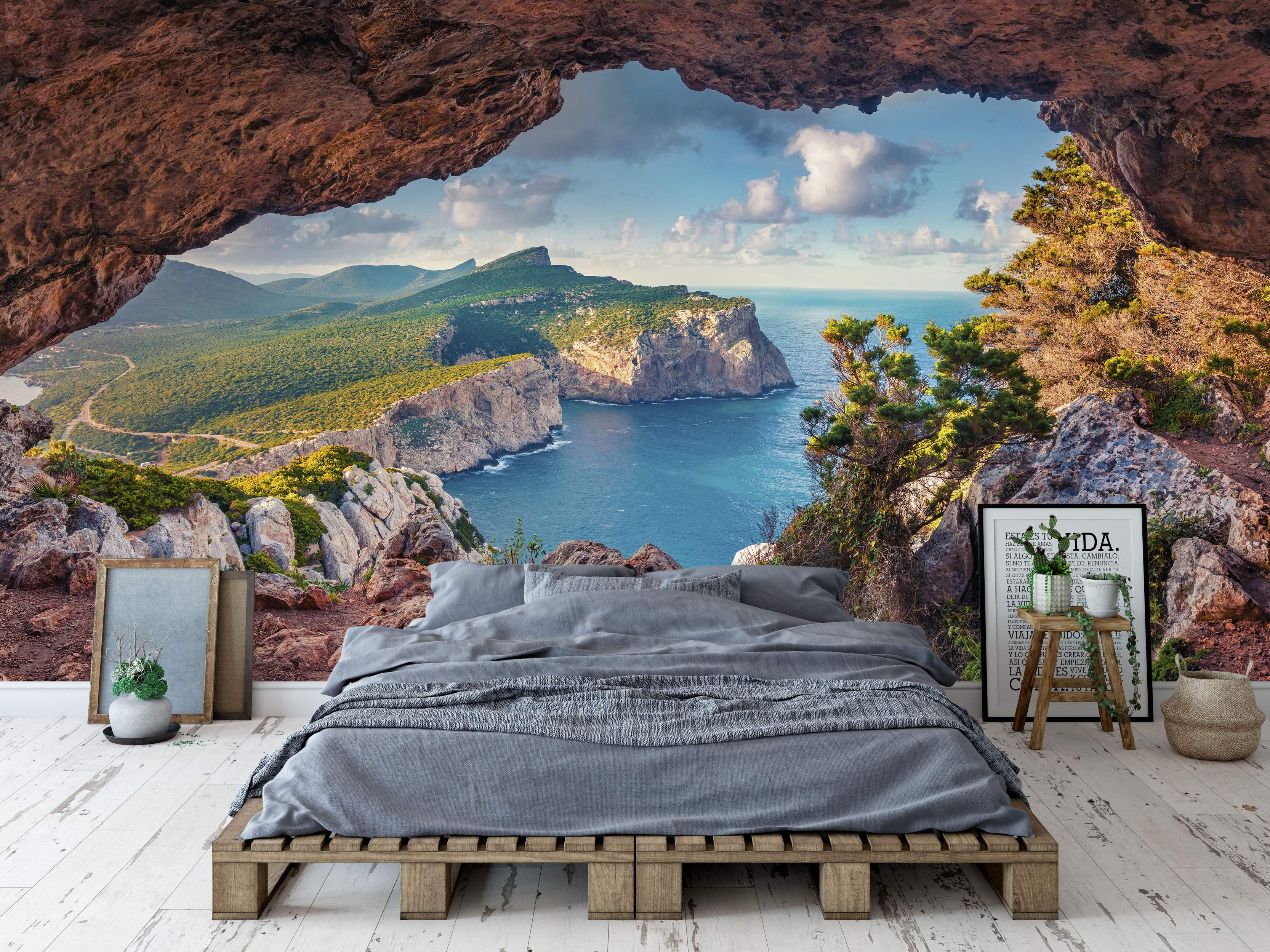 Cave view mural showing a sunny coastal scene with tan cliffs, green hills, and vibrant blue ocean under a partly cloudy sky.