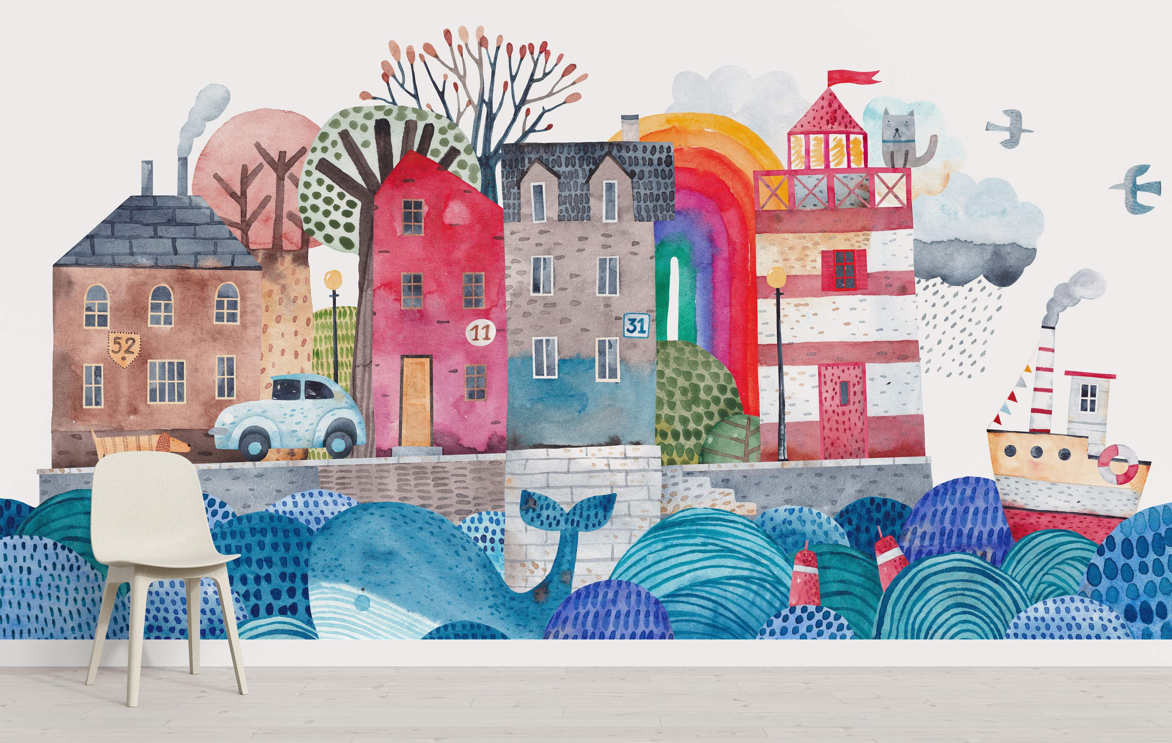 Watercolor mural of a whimsical coastal town with colorful houses, a lighthouse, a whale, a boat, and a rainbow.