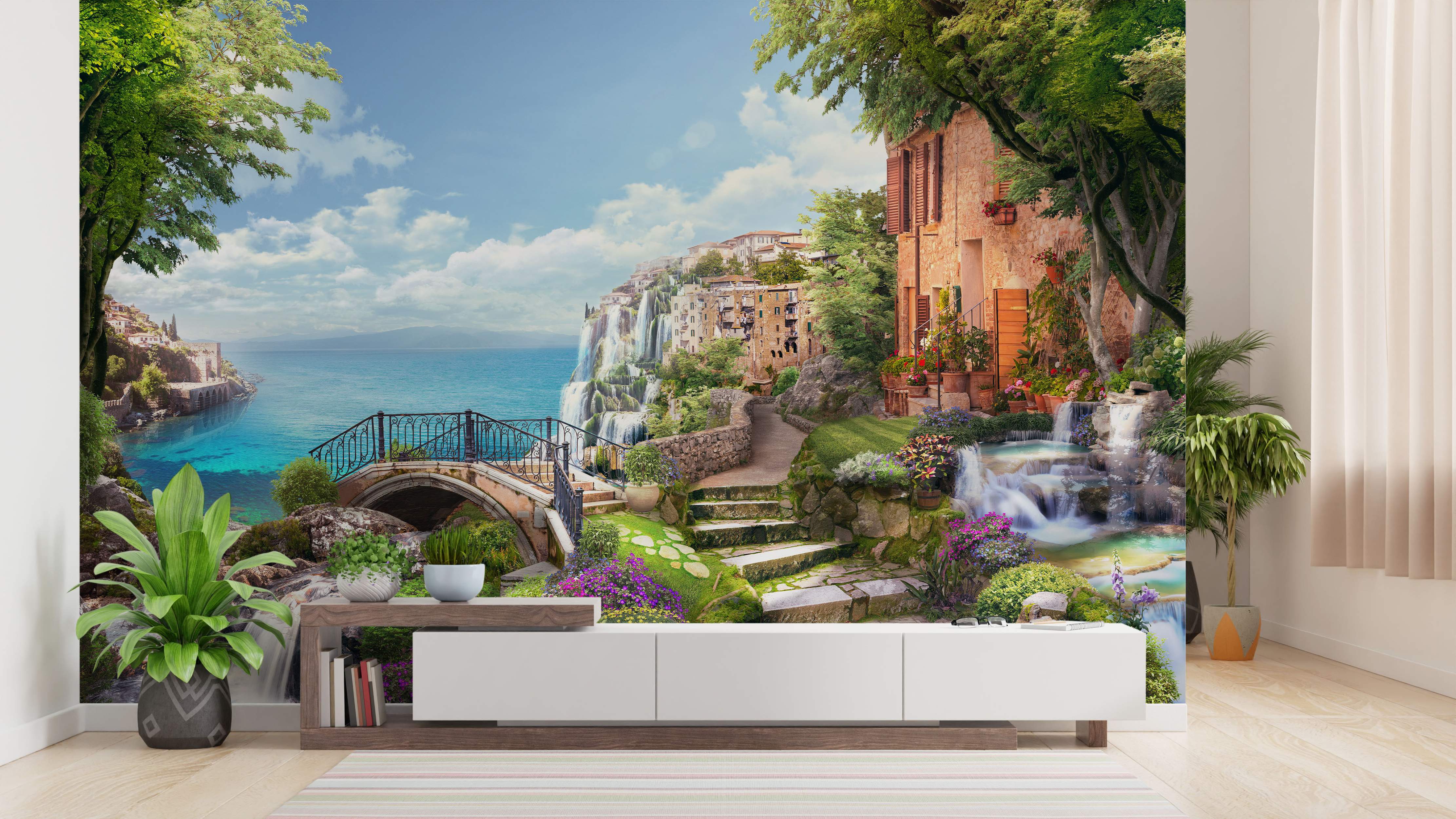 Mural of a picturesque coastal village on cliffs with waterfalls, stone buildings, green trees, and turquoise blue water.