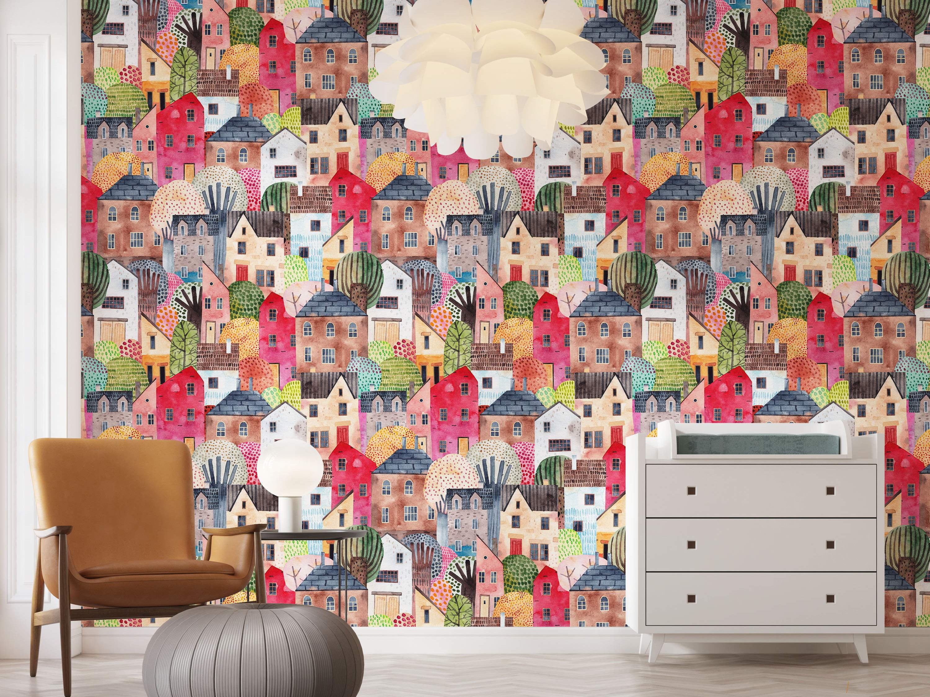 Whimsical watercolor wallpaper featuring a dense pattern of colorful houses and stylized trees in various bright and muted tones.