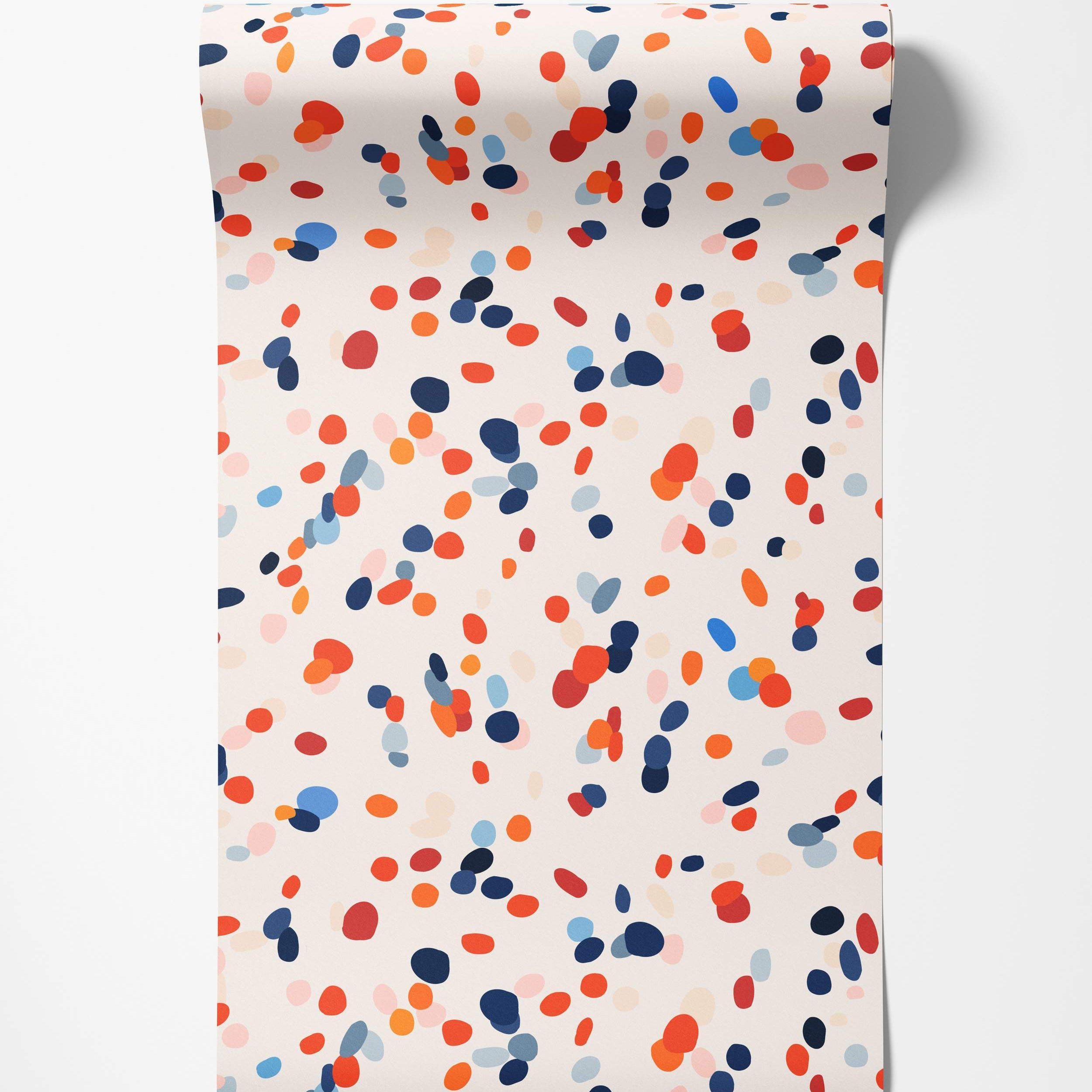 Abstract wallpaper featuring scattered oval confetti shapes in navy, red, orange, and light blue against a cream backdrop.