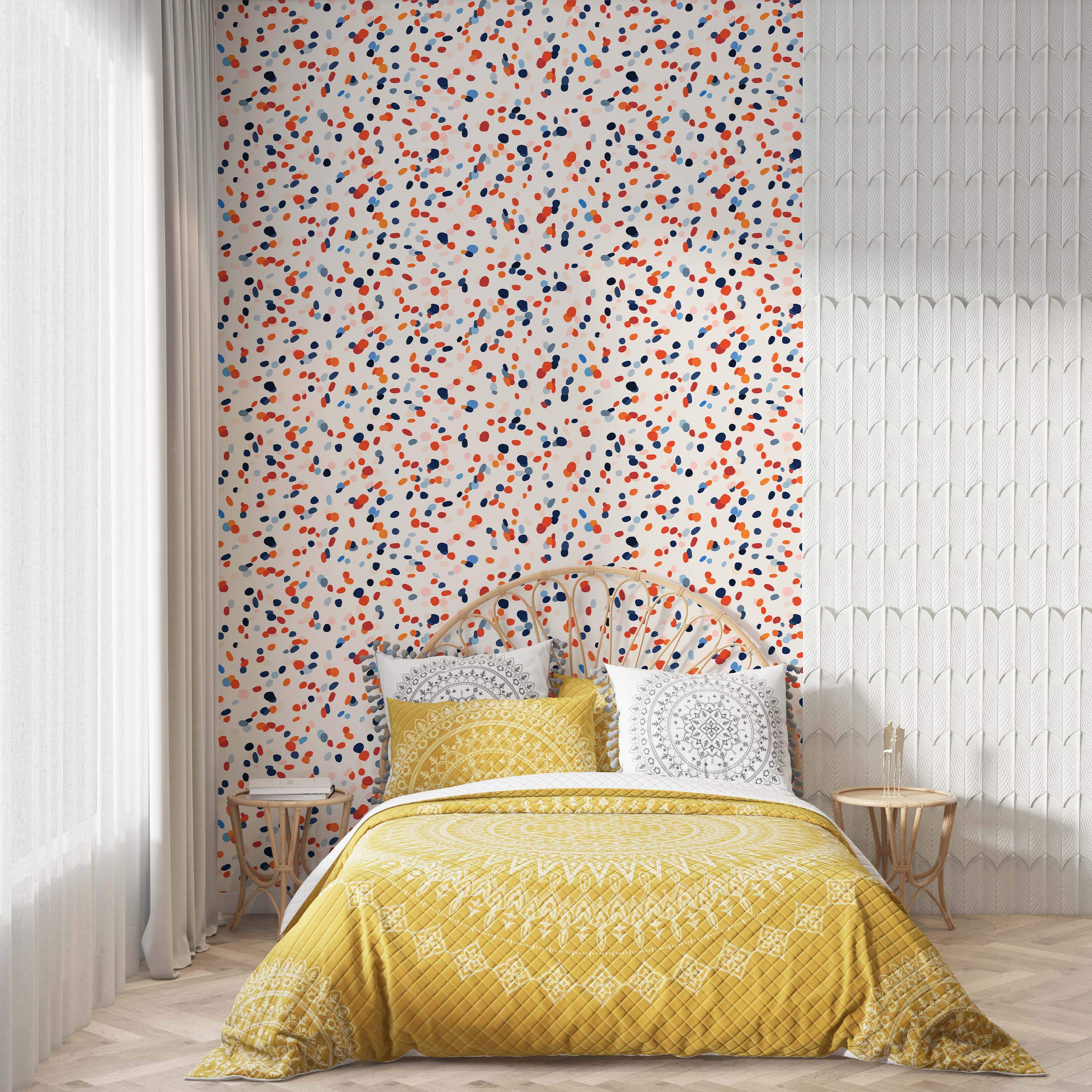 Wallpaper with a scattered confetti pattern featuring irregular dots in shades of orange, blue, and red on a white background.