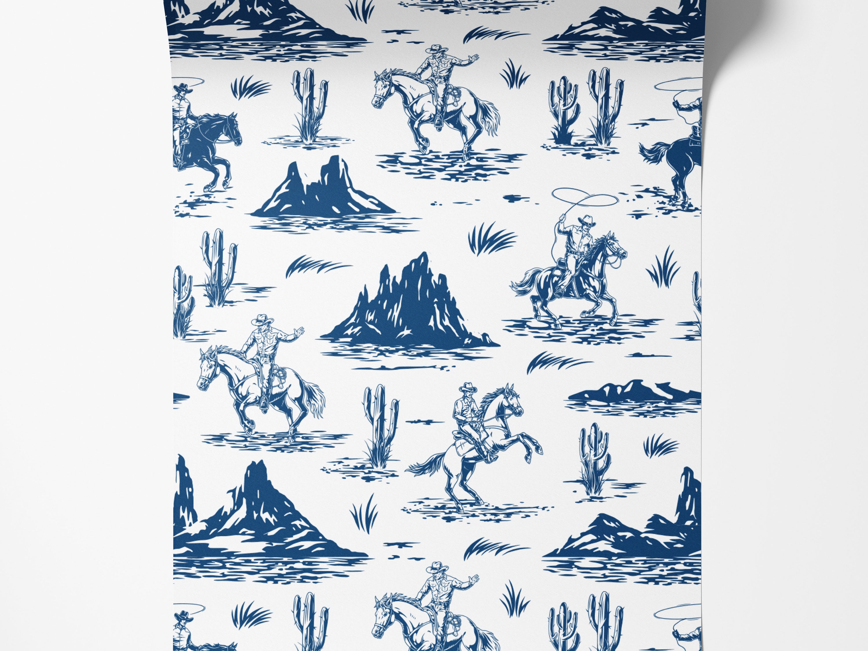 A western toile wallpaper featuring blue illustrations of cowboys, rearing horses, and desert cacti on a white background.