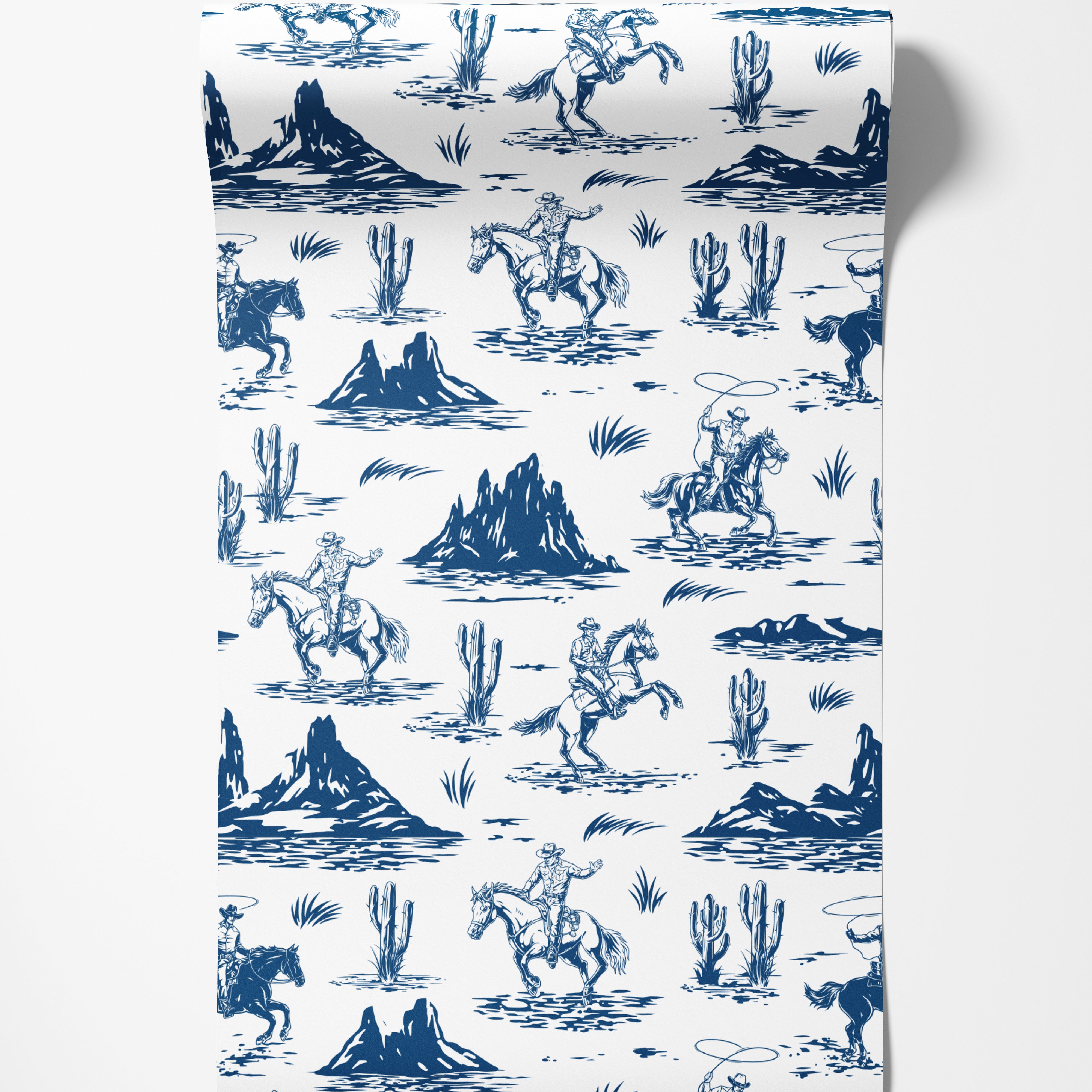 A western toile wallpaper featuring blue illustrations of cowboys, rearing horses, and desert cacti on a white background.