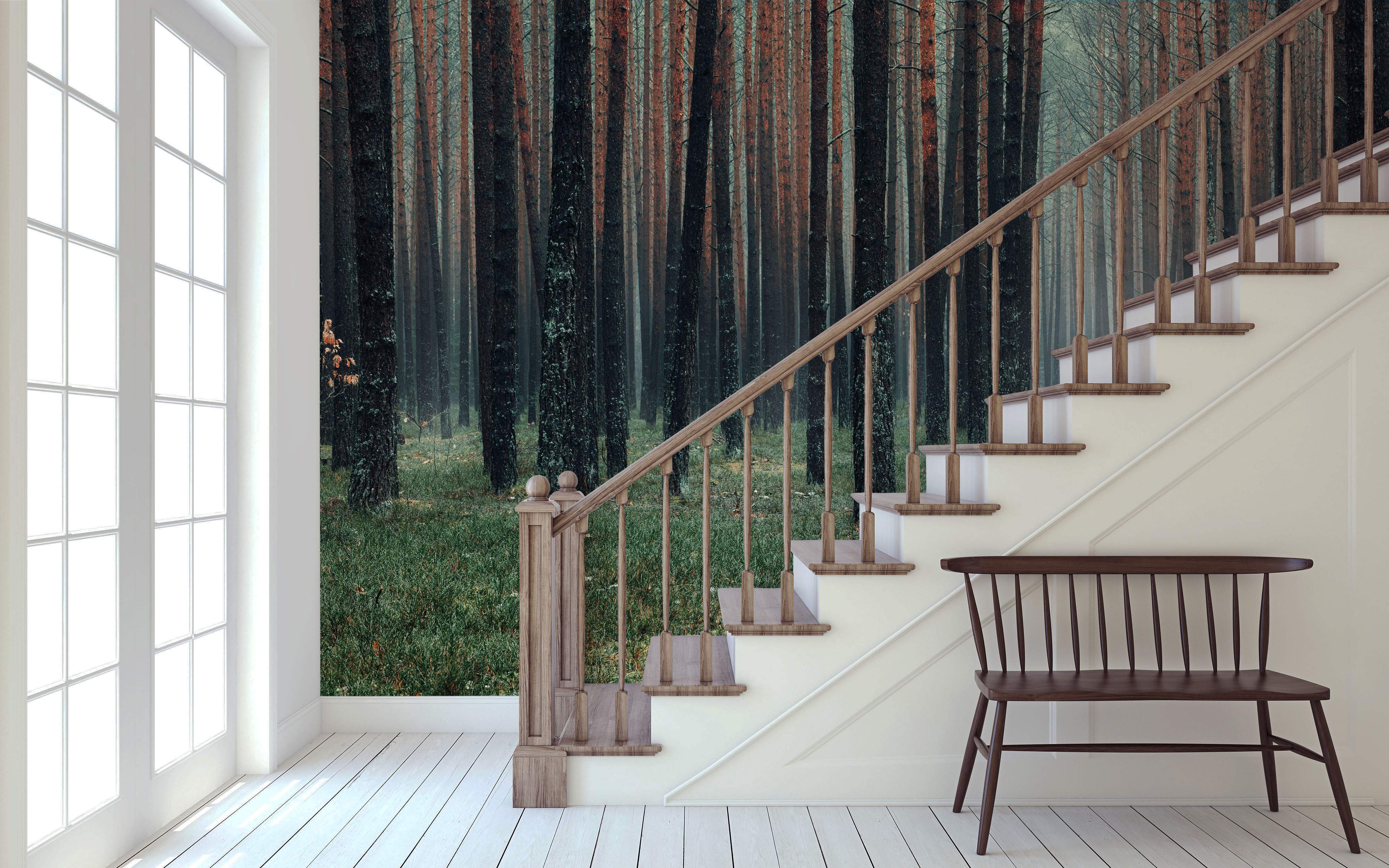 Mural of a dense, misty forest featuring dark, tall tree trunks with reddish tones over a green grassy floor.