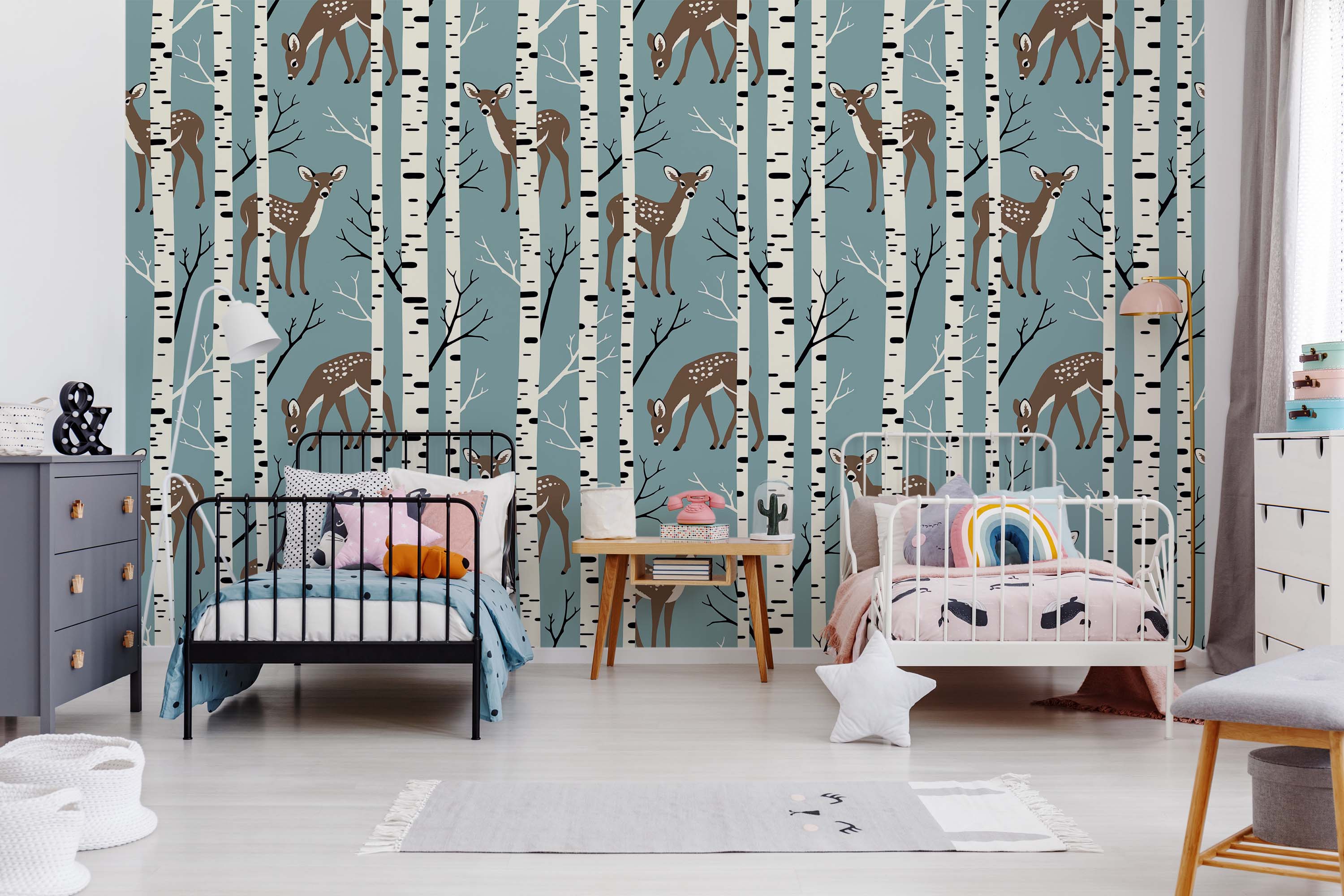A whimsical wallpaper featuring brown fawns among white birch trees on a dusty blue background.