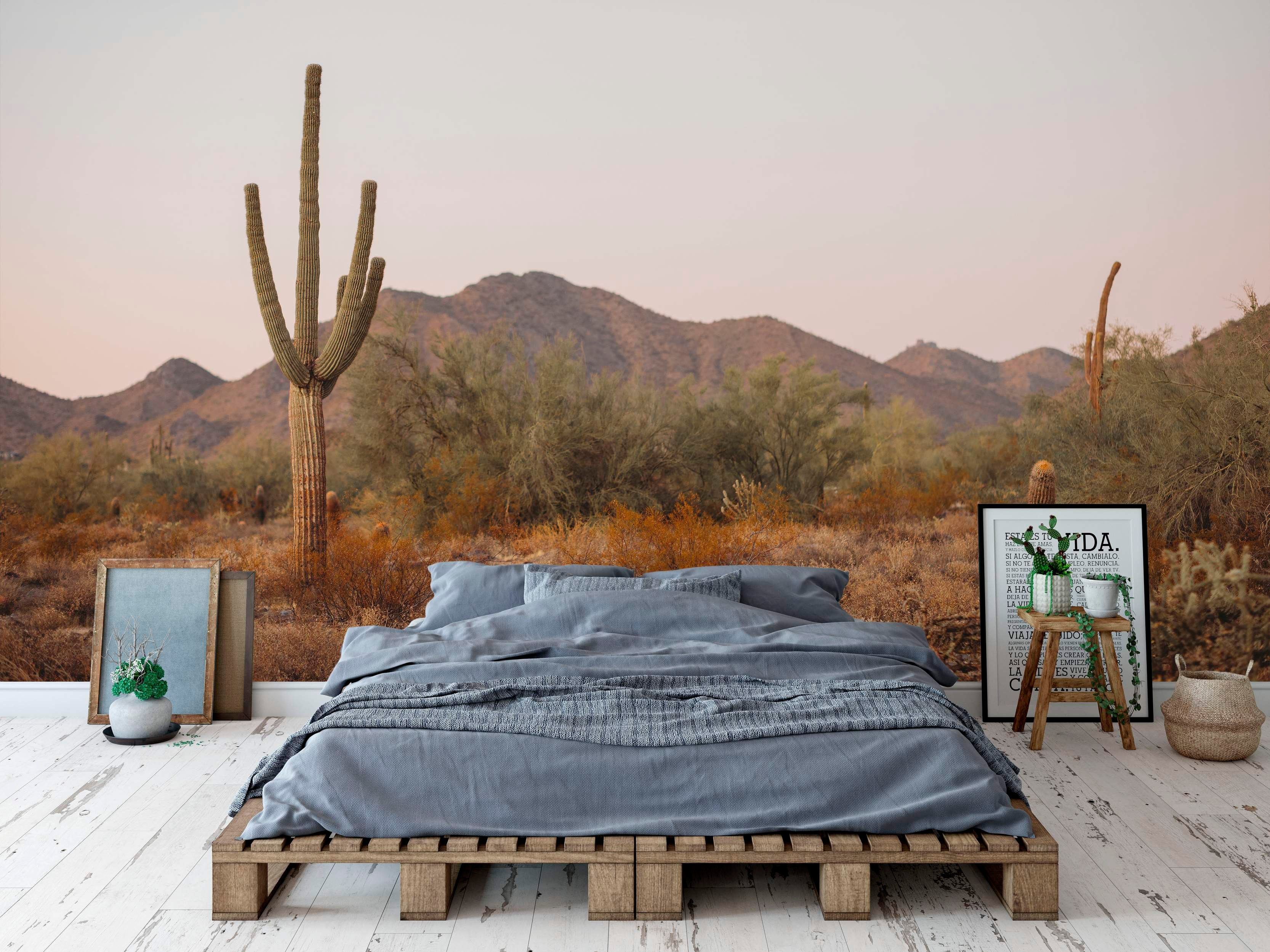 Desert landscape mural with cacti and mountains.