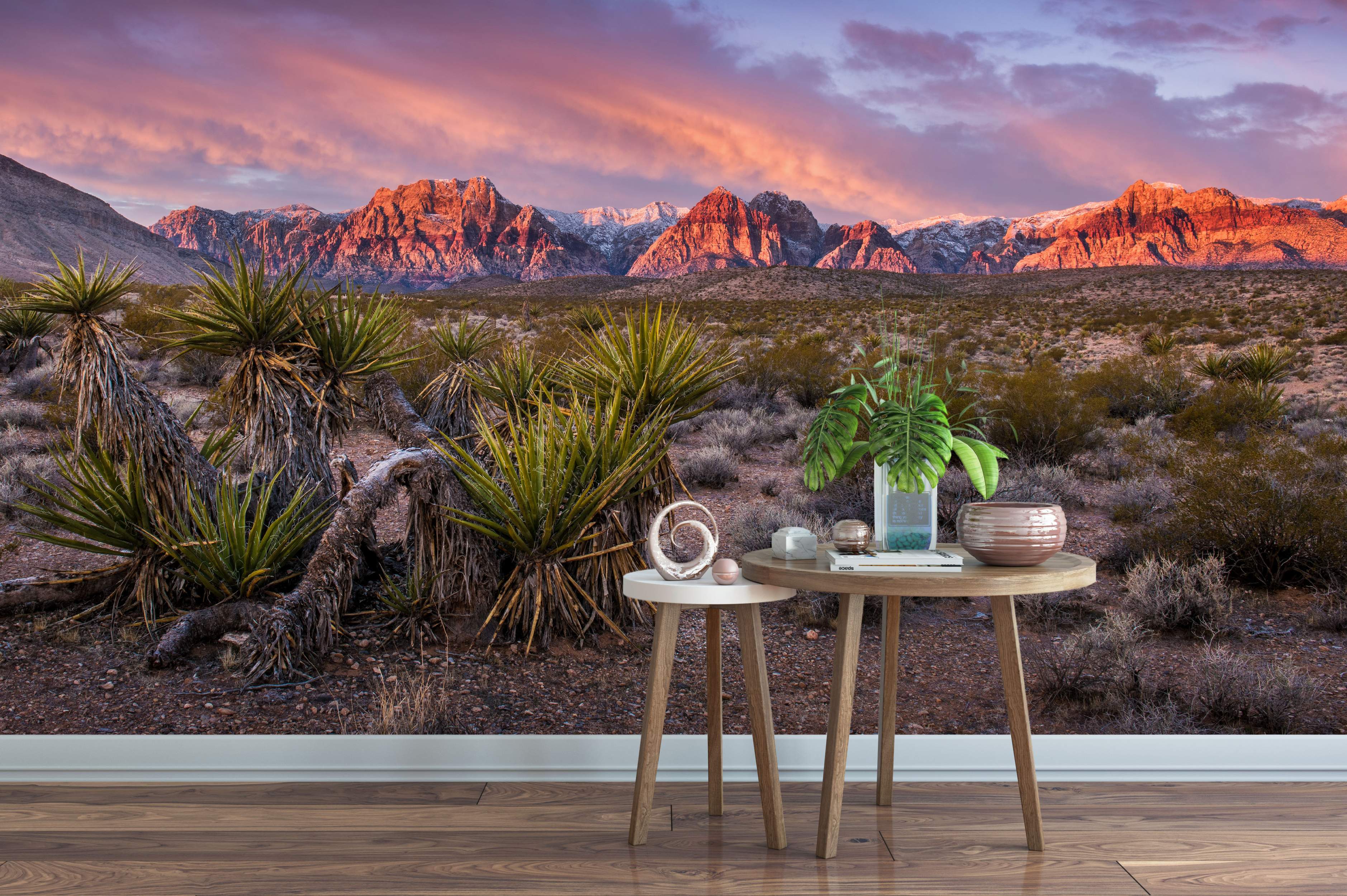 Photorealistic desert landscape mural with yucca plants, snow-dusted mountains glowing pink and orange under a vibrant sunset sky.